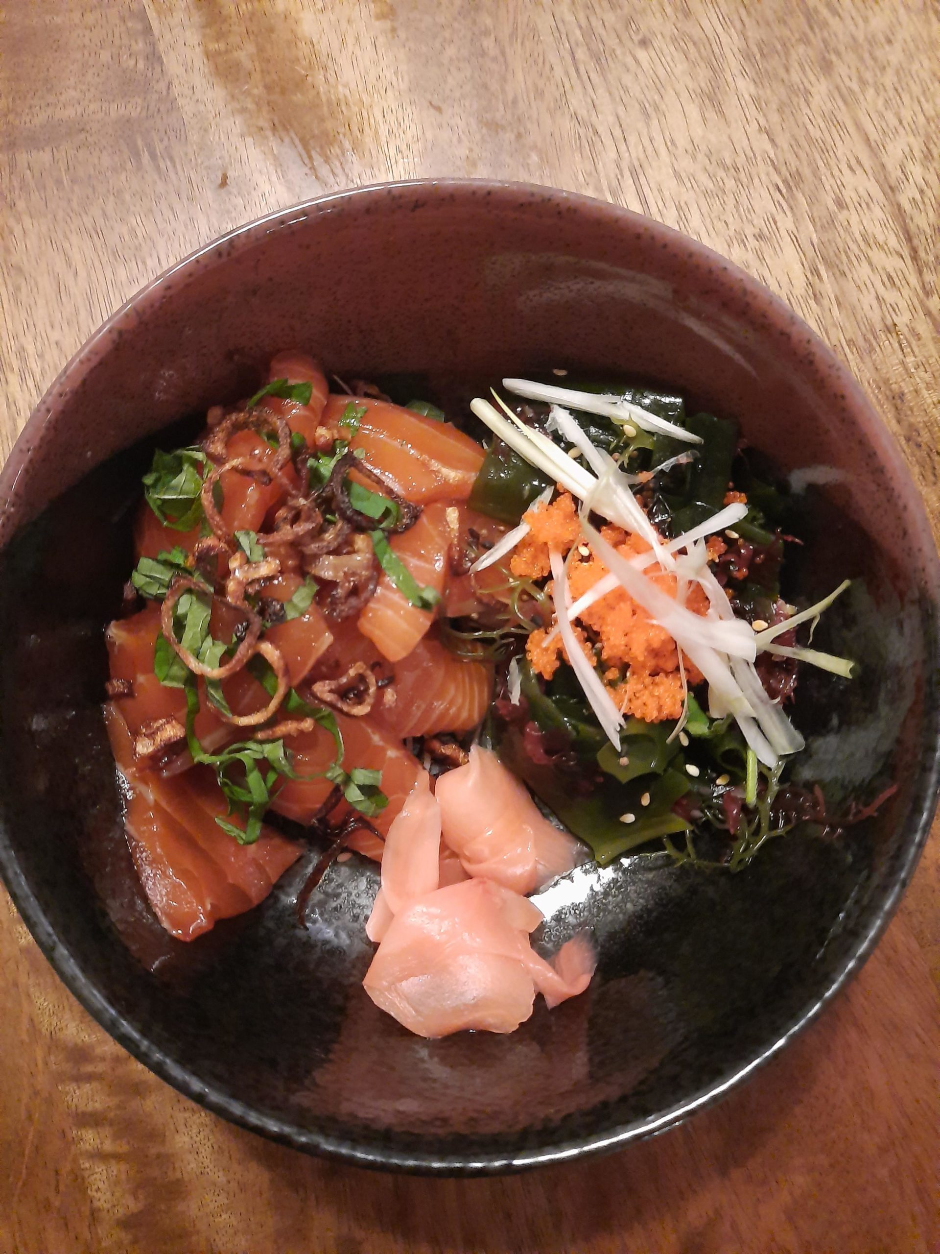 Raw tuna in rice oil and mirin, topped with fried shallots. Seaweed and daikon salad in sesame