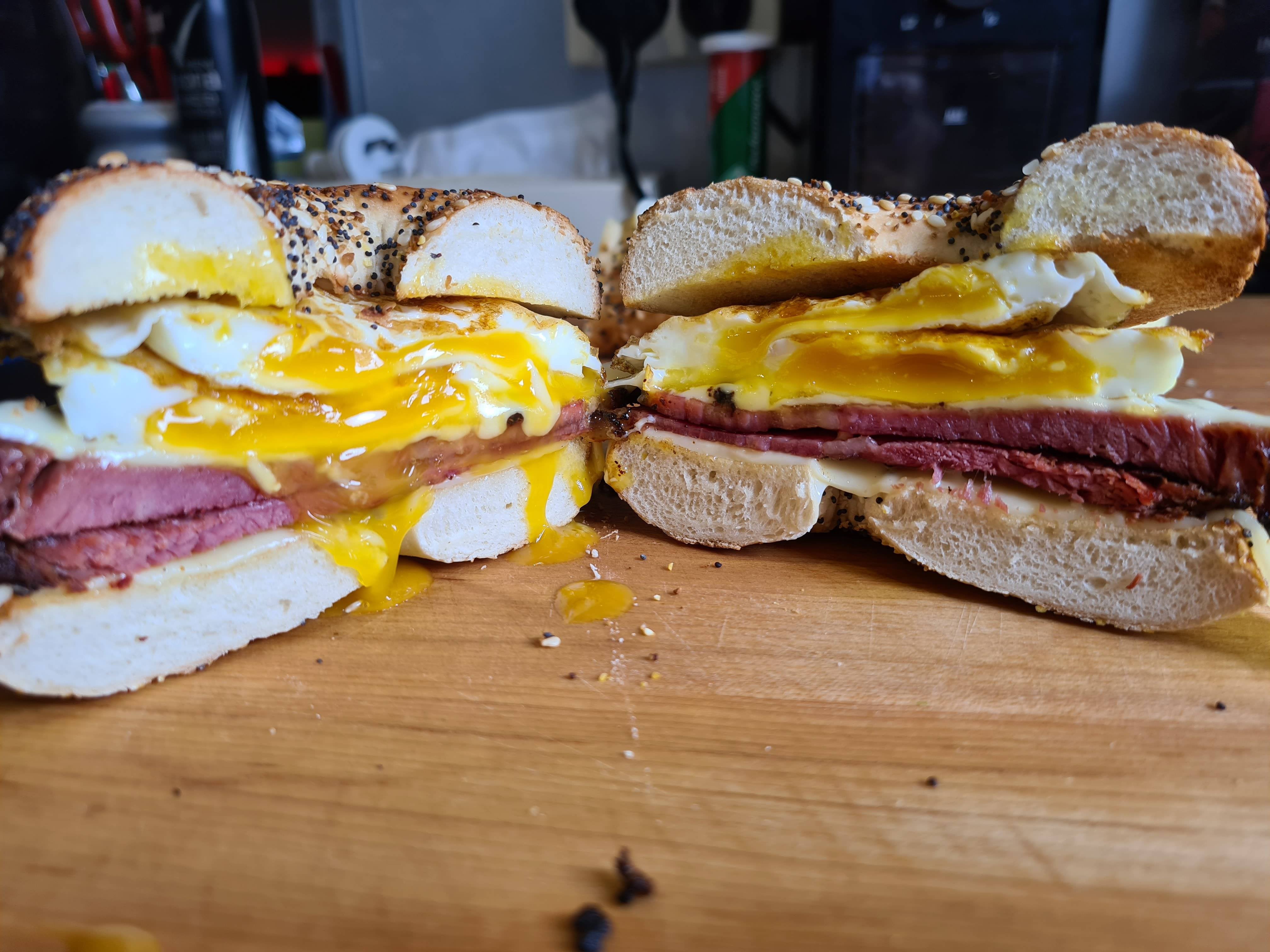 Homemade pastrami, eggs and Swiss on a toasted everything bagel