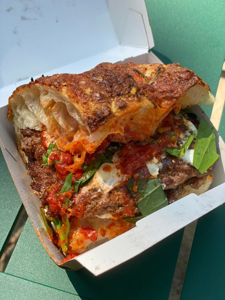 Shake Shack x Mama’s TOO! Collab: two smashed Shack patties with Stracciatella cheese, spicy ‘nduja tomato sauce, and bitter greens in Mama’s TOO!’s focaccia baked with mozzarella, Parmesan, and rosemary