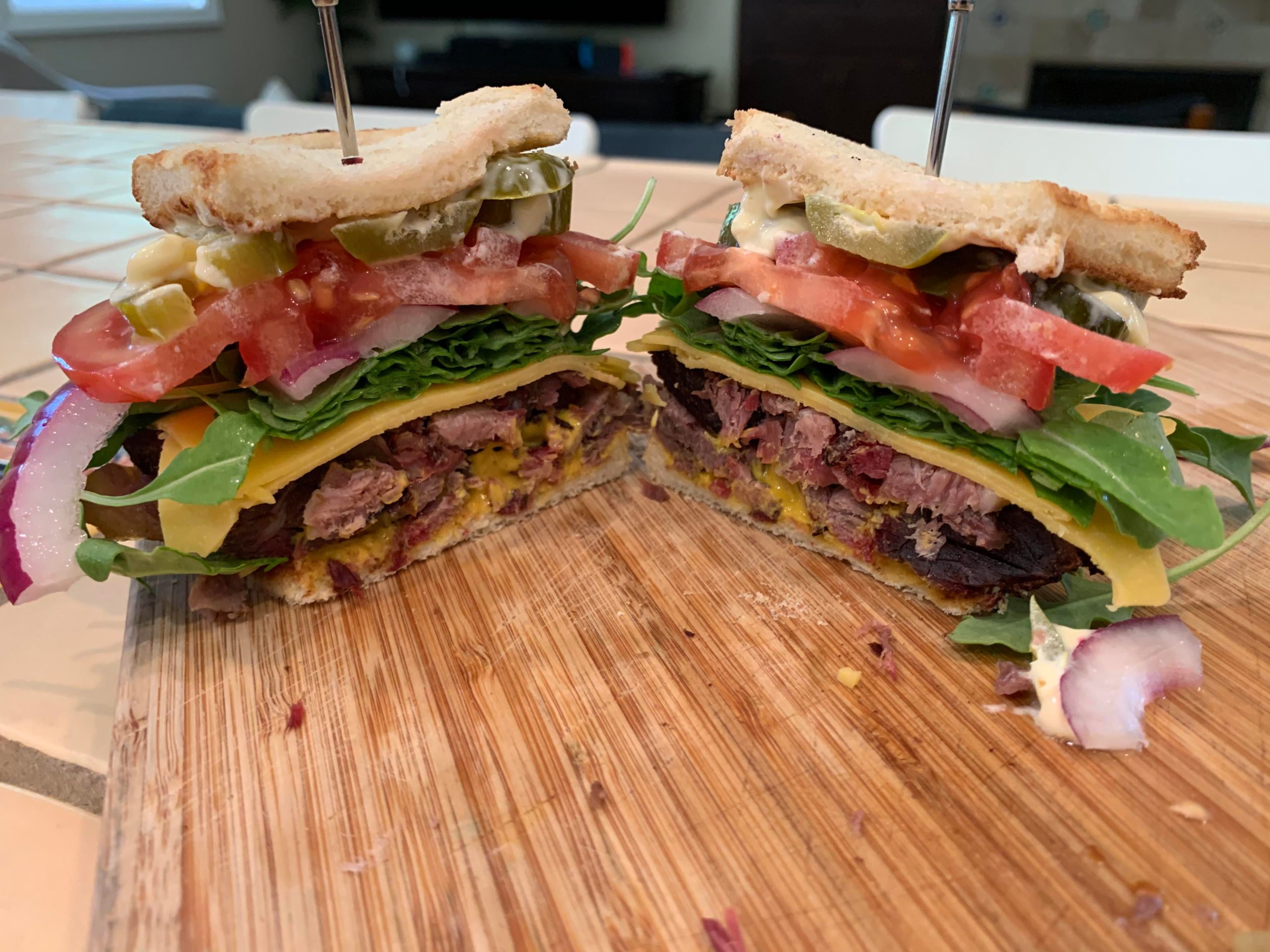 Smoked brisket with arugula, pickles, pickled jalapeño, cheddar, tomato