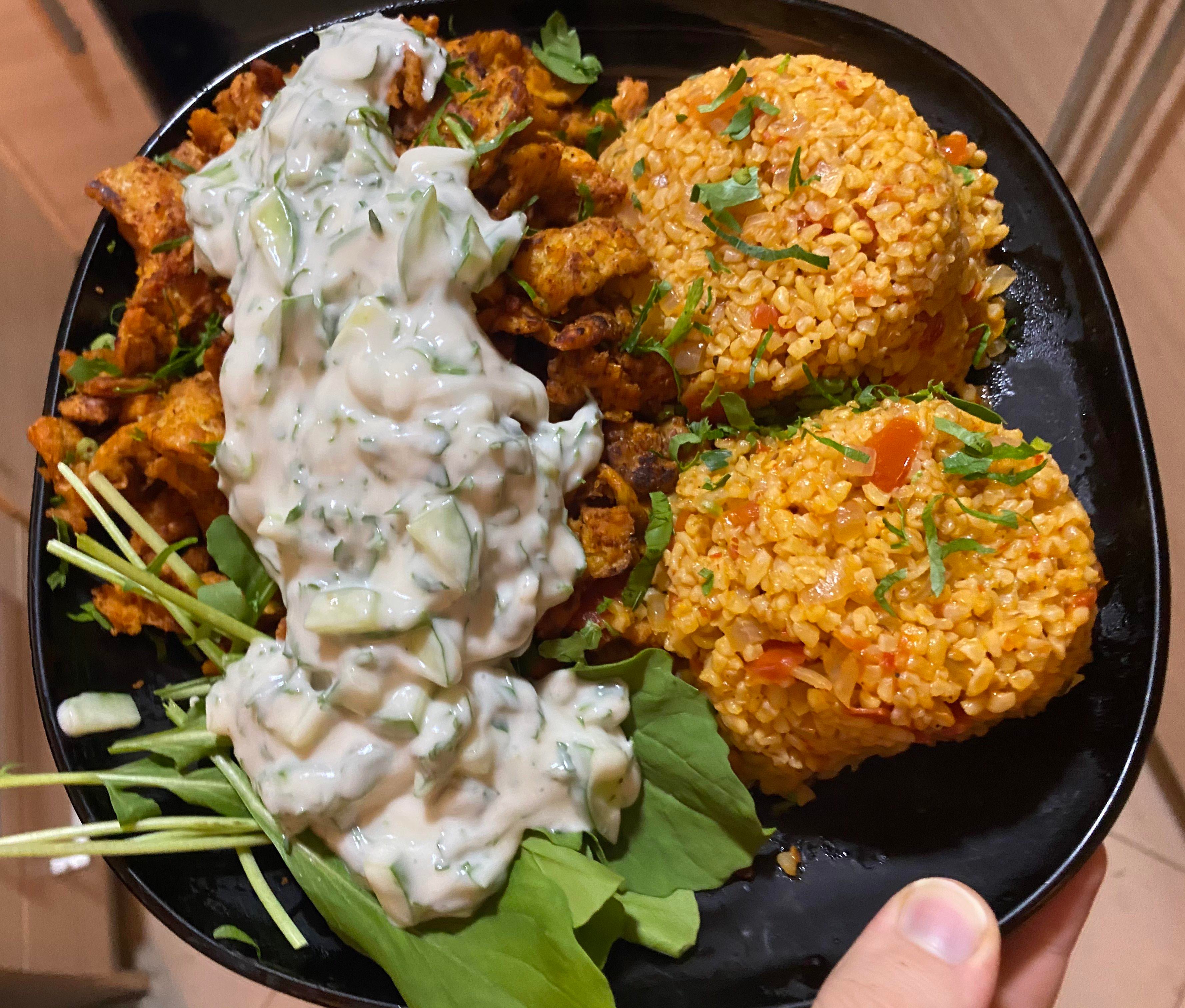 Tomato bulgur pilaf with shawarma soy curls and cucumber parsley cashew