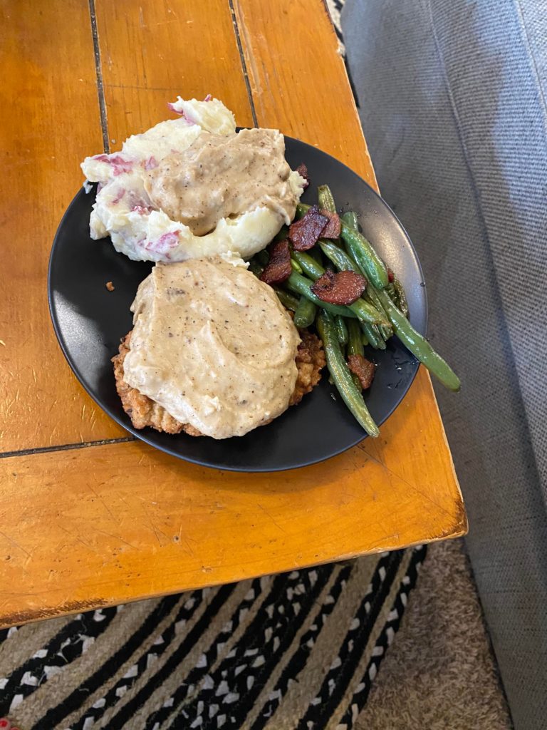 Chicken fried steak with mashed potatoes and gravy (plus their friend bacon green beans)