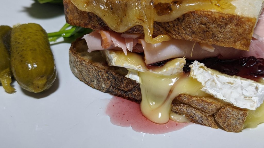 Brie, truffle ham, cranberry sauce on sourdough topped with cheddar