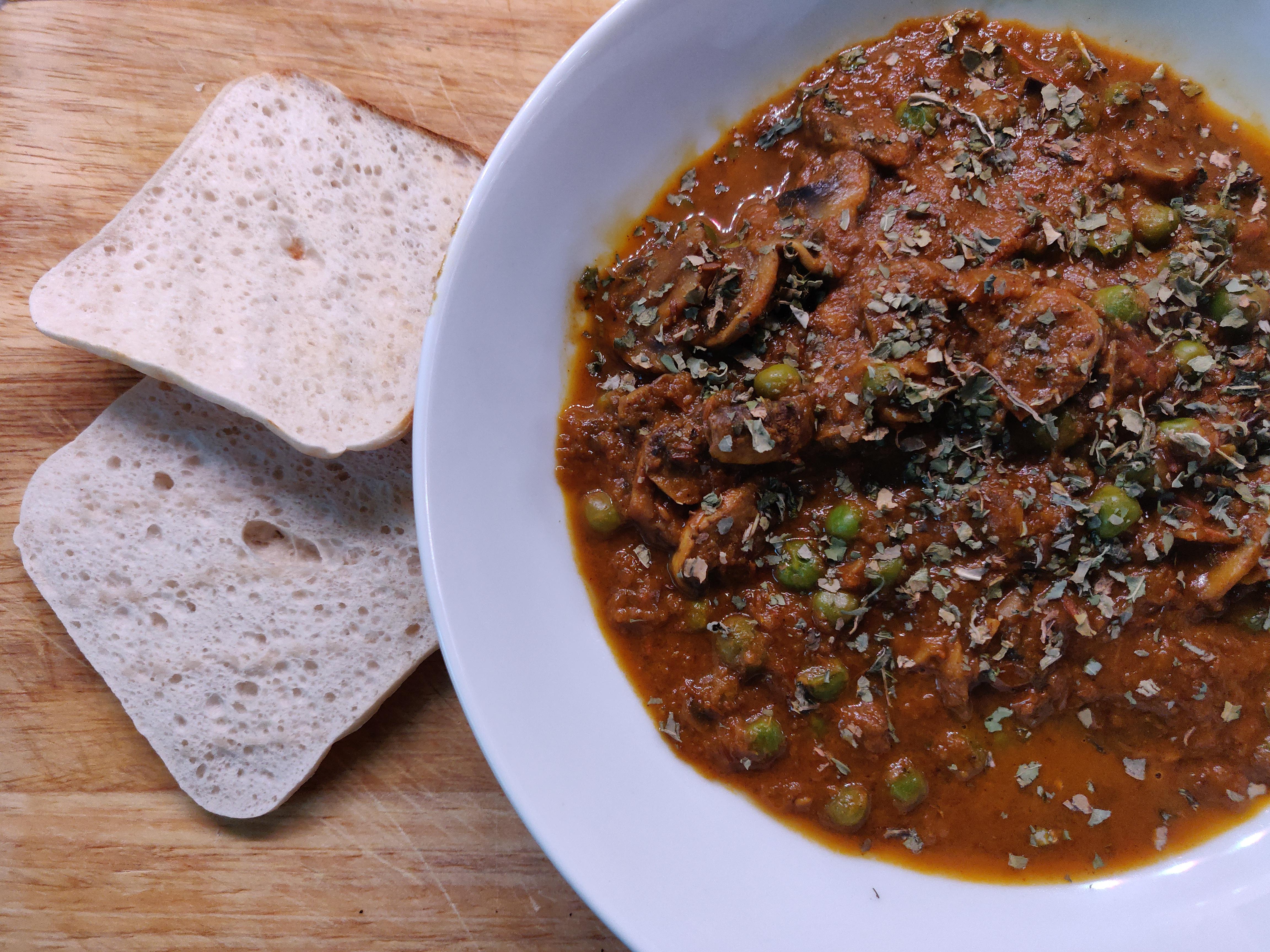 Matar Mushroom Curry. 257 calories for the mushrooms and peas, 100 cal for the bread = 357 total