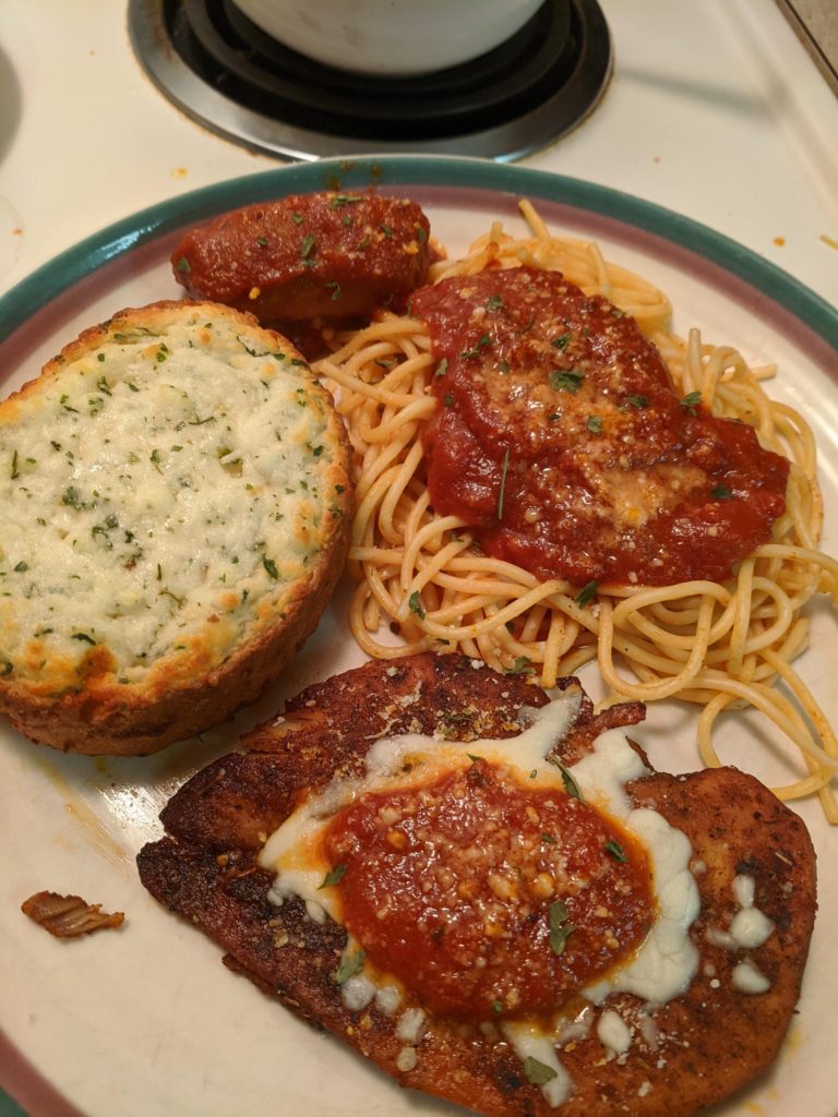 Homemade tomato sauce, chicken parm and garlic bread.