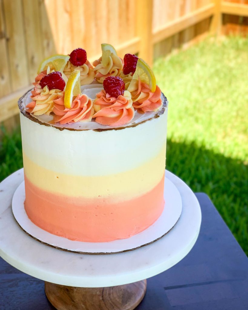 A lemon raspberry cake with 4 layers of lemon poppyseed cake filled with lemon cream cheese frosting, homemade lemon curd and homemade raspberry preserves to ring in the end of summer!