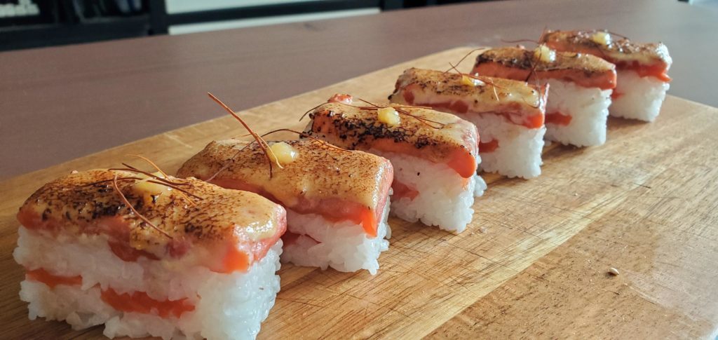 Practicing making a different style of sushi. Some seared oshizushi with wild sockeye salmon, sauce, yuzu, and chili threads!