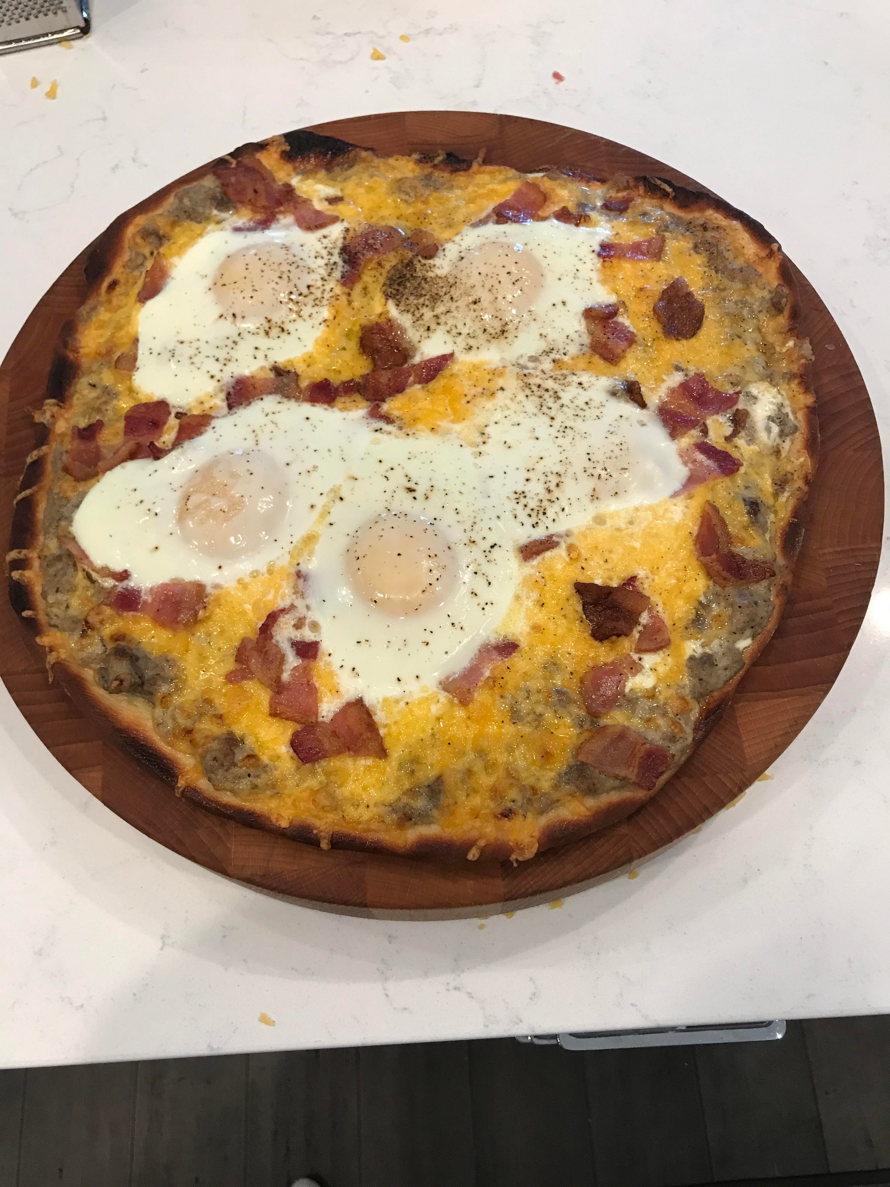 Breakfast pizza with sausage gravy, bacon, cheese and eggs! Dining