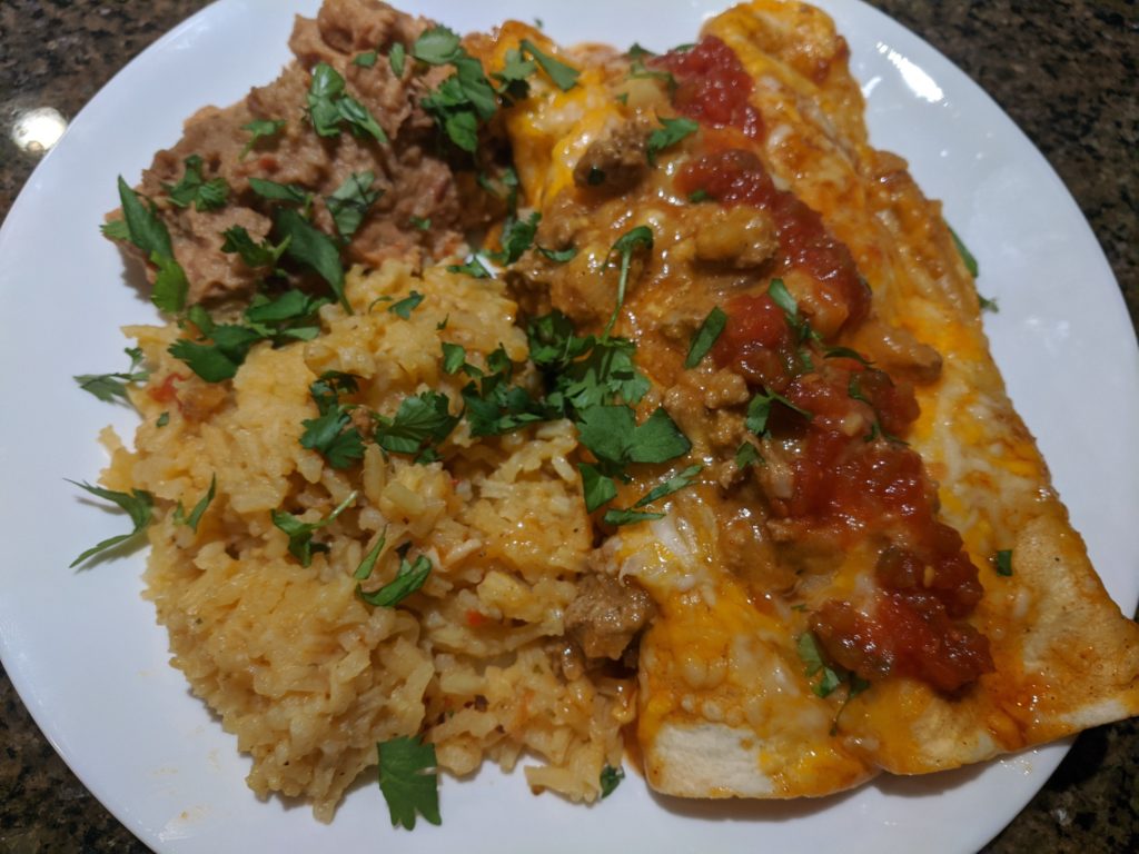 Enchiladas with refried beans and rice