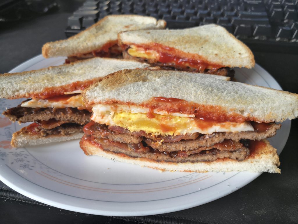 A very simple Double Smash Burger (x2 bacon, egg) on white bread