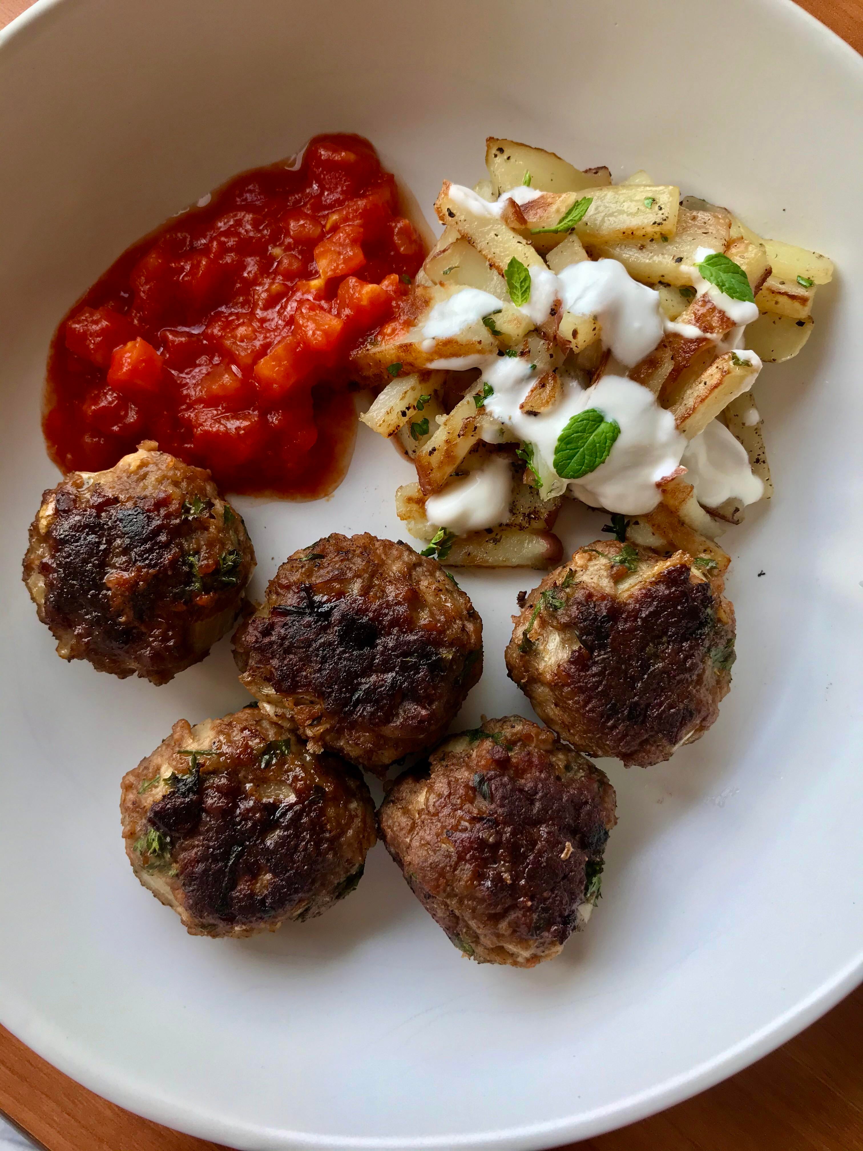 Vegan Turkish style meatballs with garlic tomato sauce, home fries and