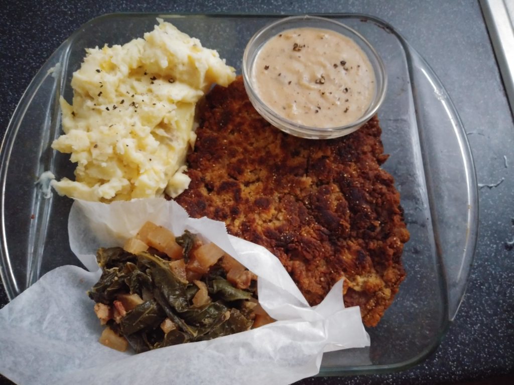 Chicken-fried steak, mashed potatoes, gravy, and collard greens