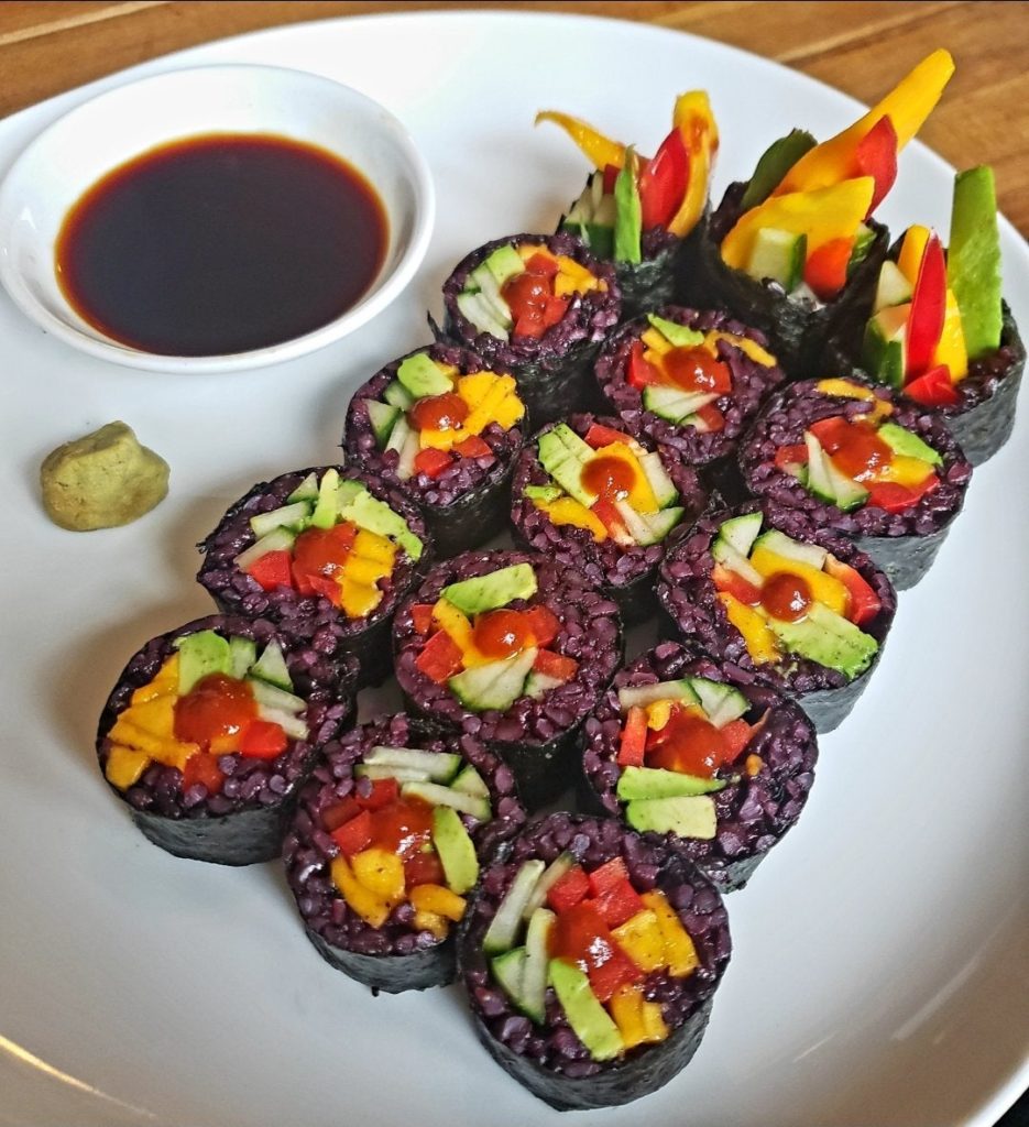 Spicy mango and avocado sushi with black rice