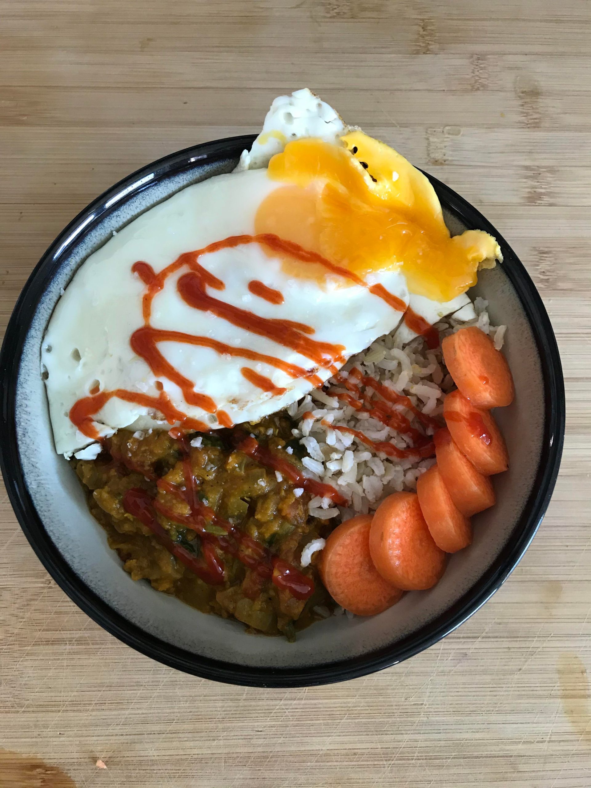 Homemade lentil daal with brown rice and two fried eggs for 650kcal