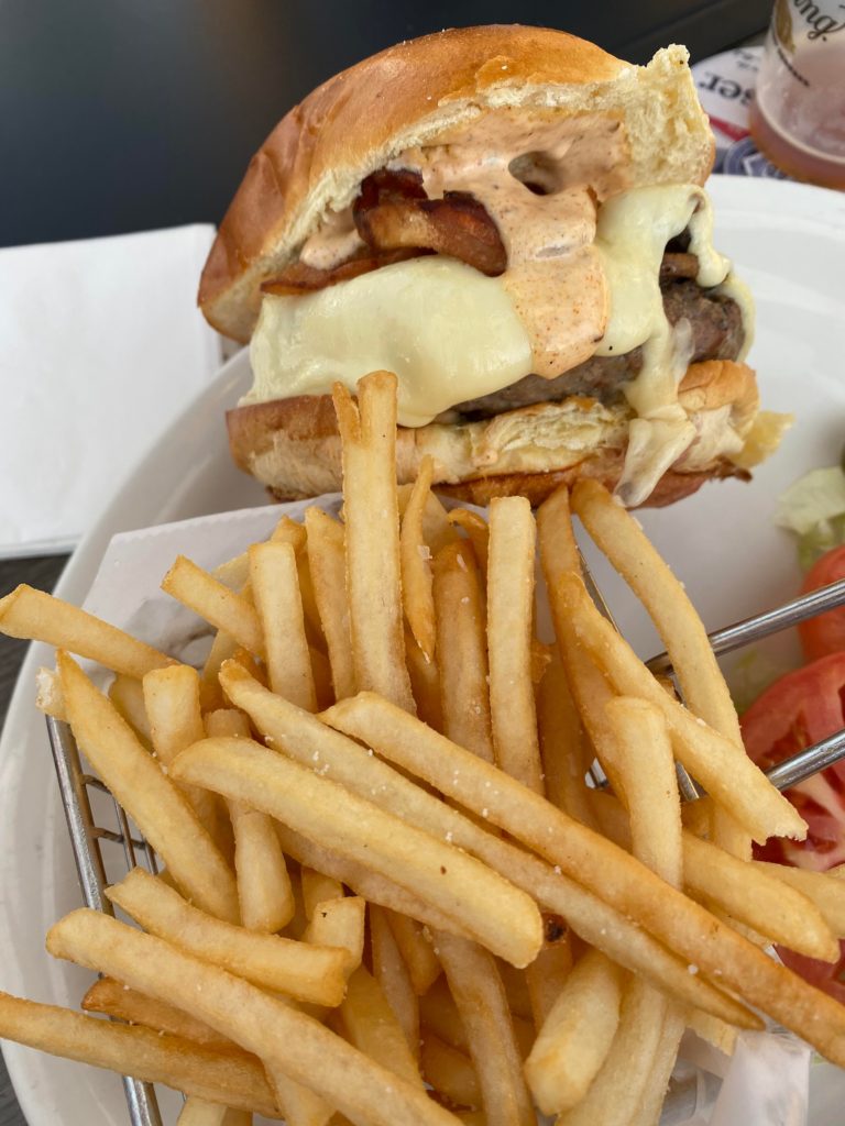 Burger with swiss cheese, bacon, and cajun mayo