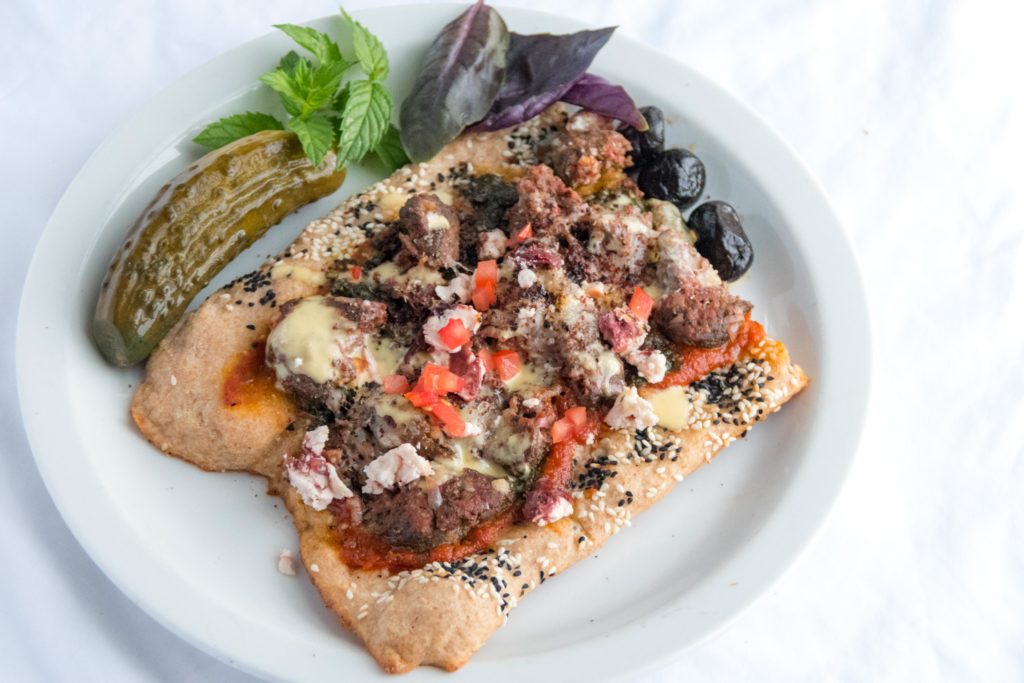 Middle Eastern flatbread with Lebanese sausage, Za'atar pesto, and garlic sauce.
