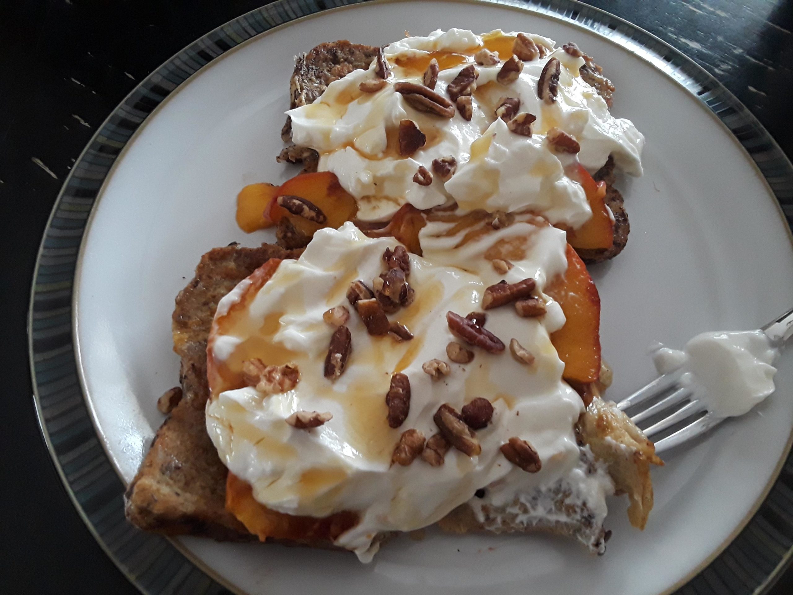 French toast with peaches cooked in butter, greek yogurt, maple syrup