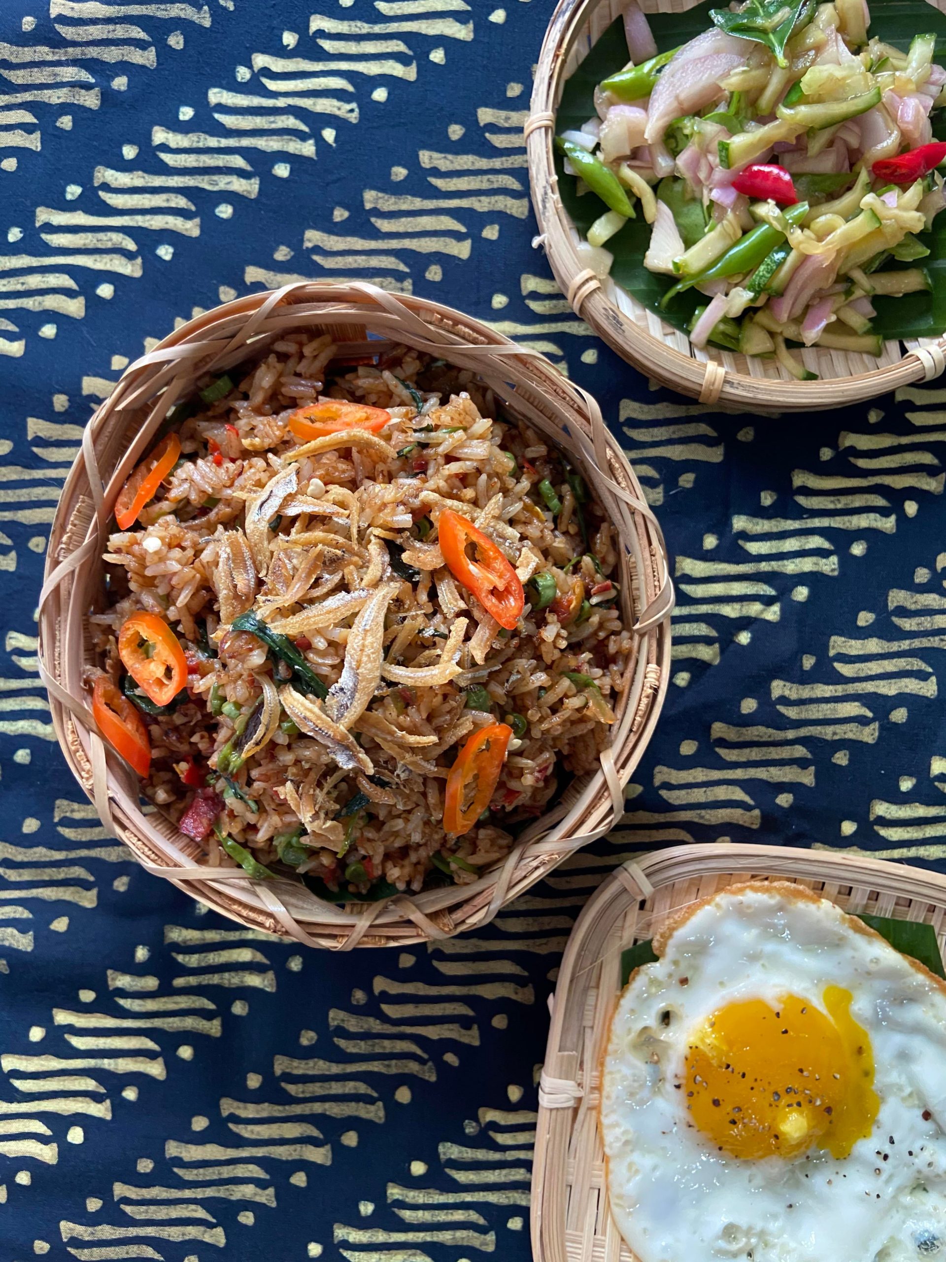 Malaysian Fried Rice (Nasi Goreng) with egg and cucumber salad prepared