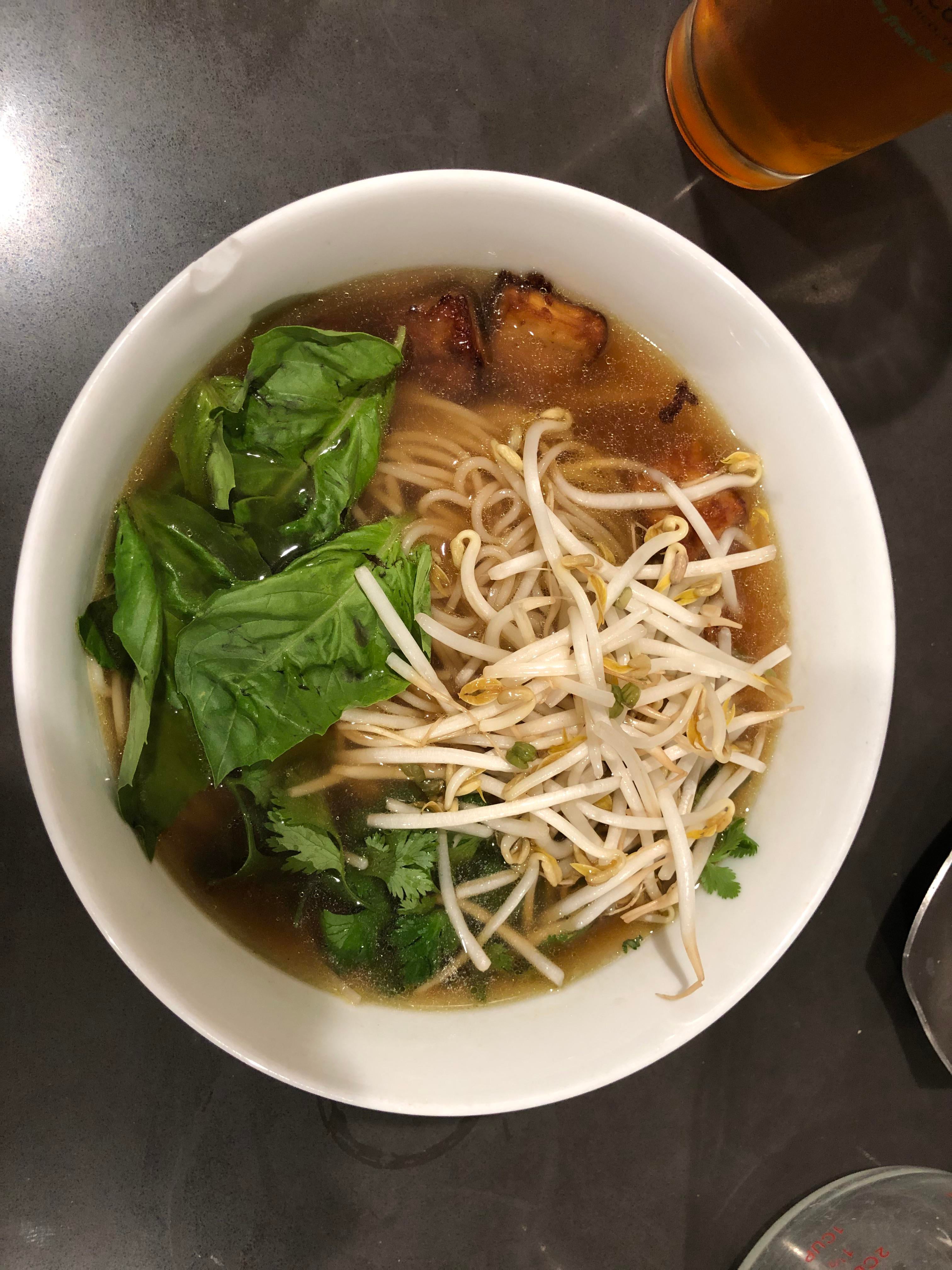 Vegan Pho with baked tofu, basil, cilantro, and bean sprouts Dining