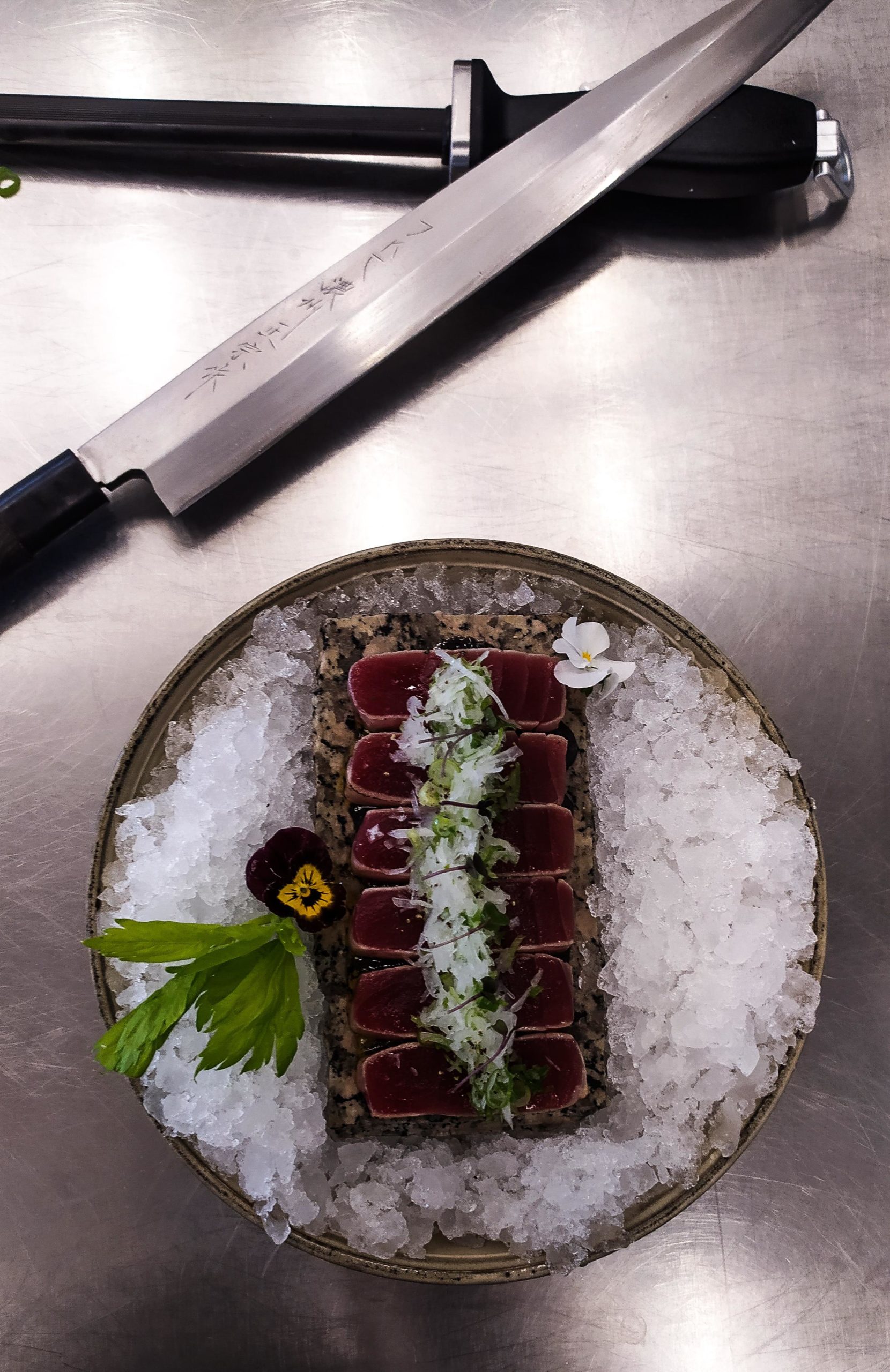 Fresh yellowfin tuna tataki seared with blowtorch on black truffle goma