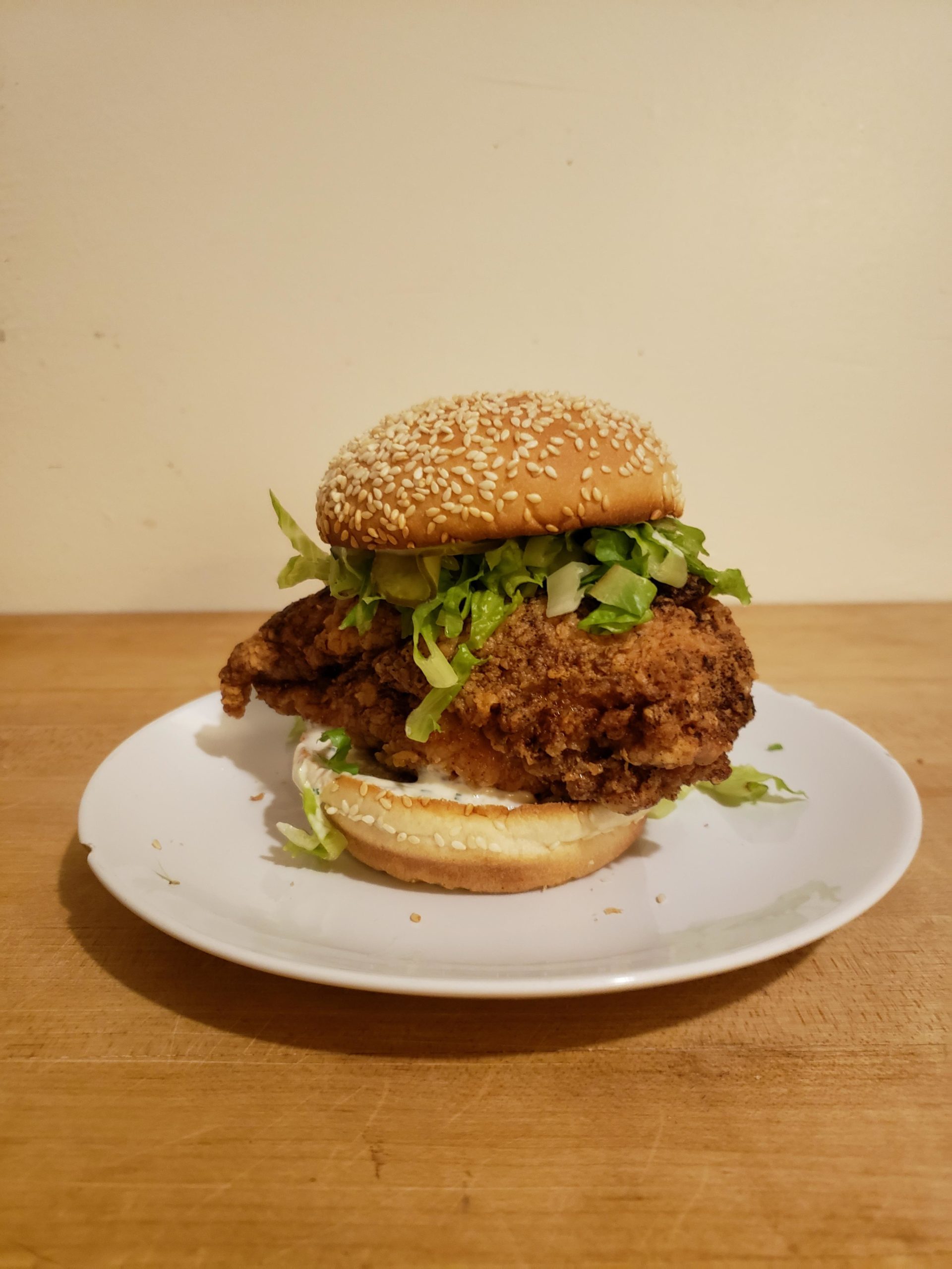 Homemade fried chicken with lettuce, bread and butter pickles, chive