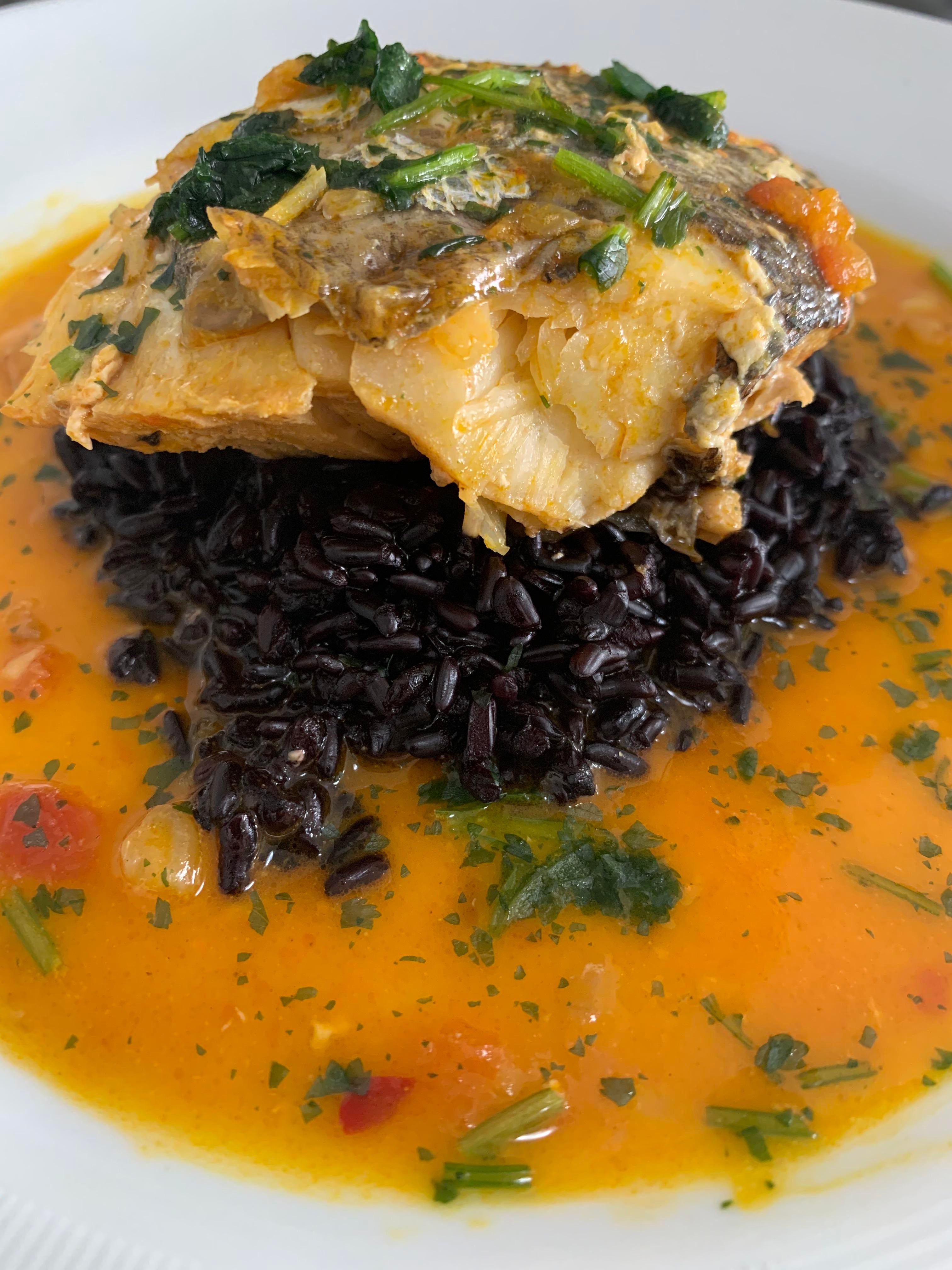 Fish moqueca with black rice. Typical dish from northeastern Brazil ...