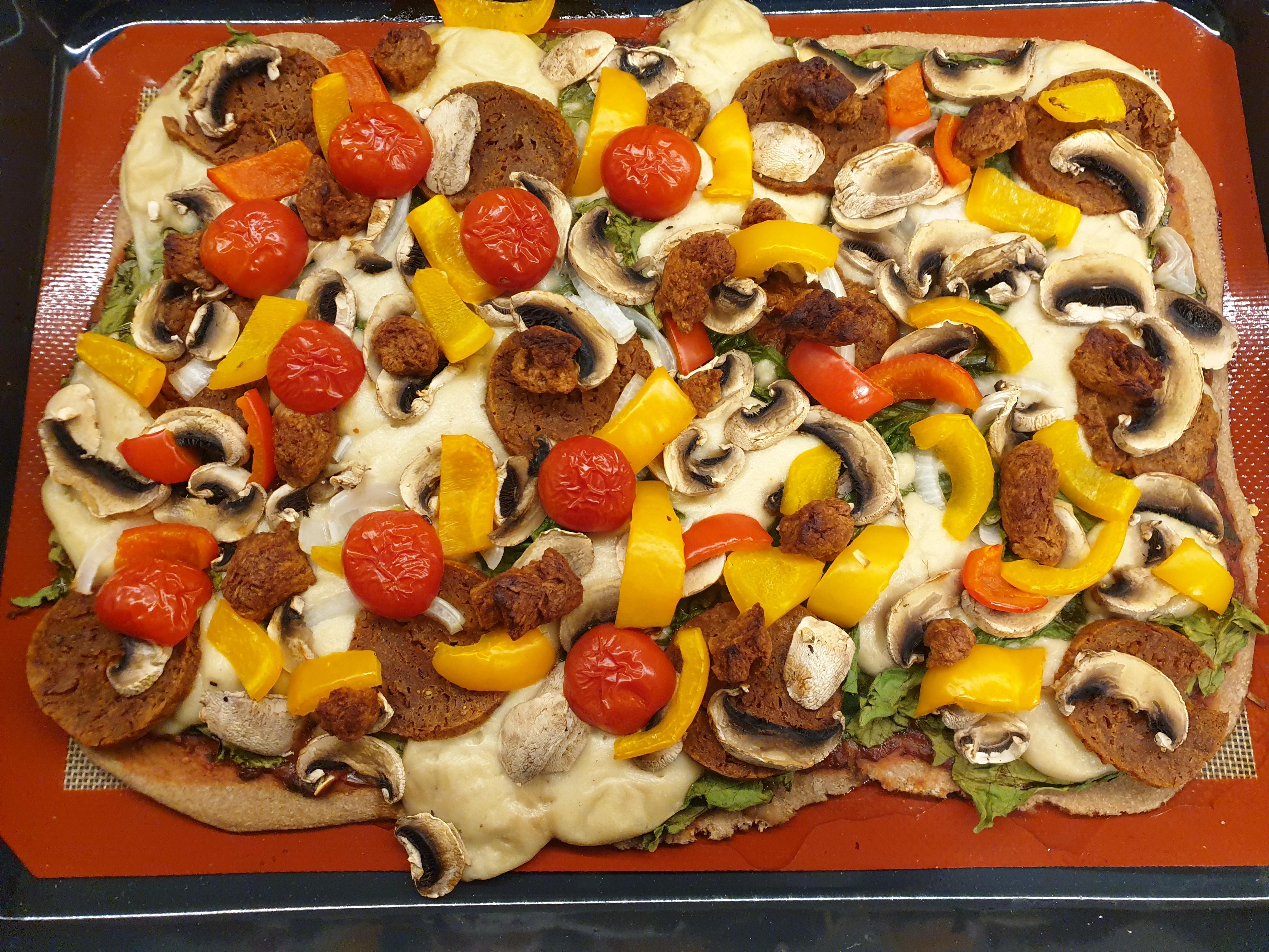 All homemade pizza with salami (seitan), BBQ soy curls, cashew