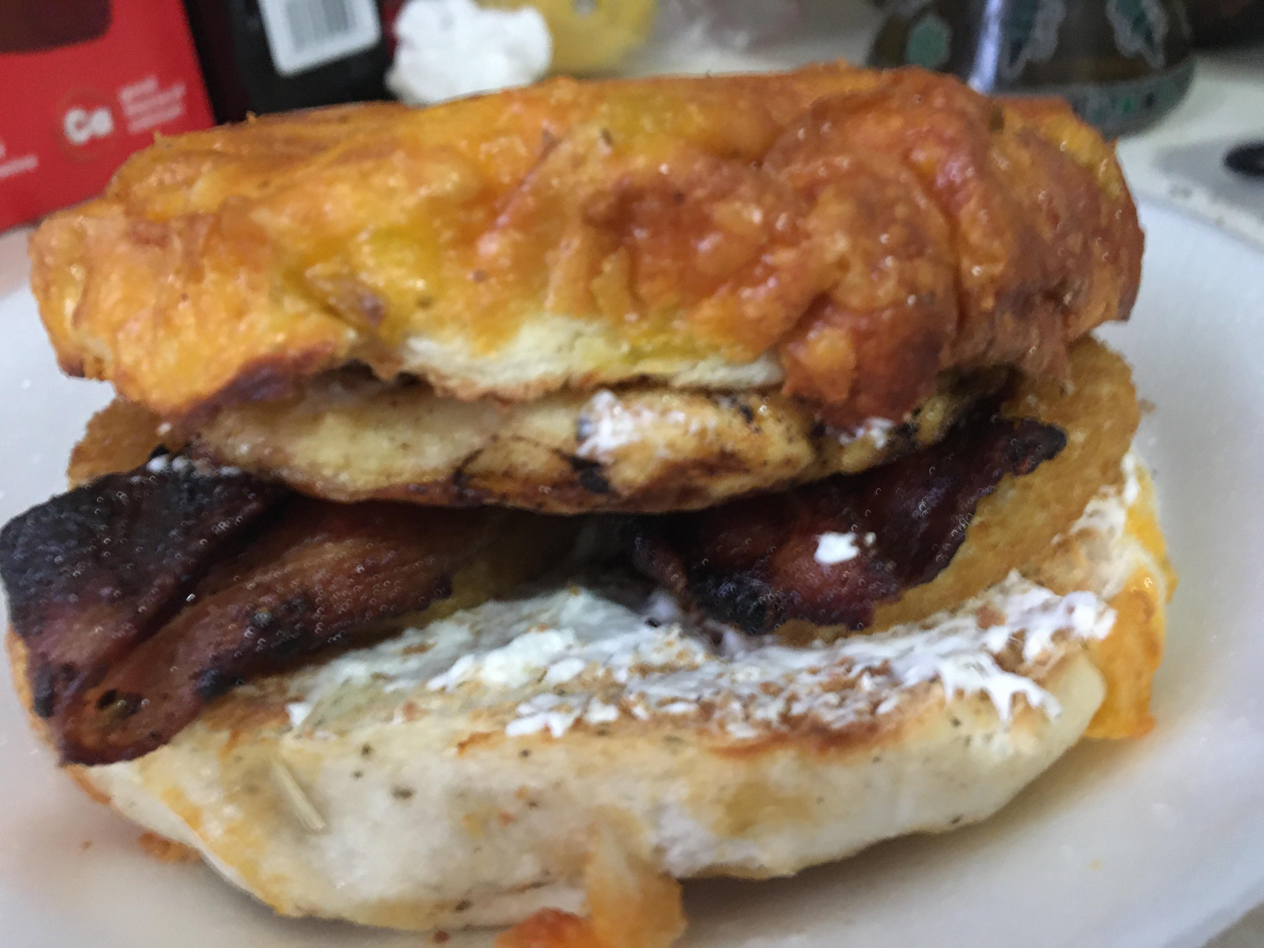 Bacon, egg, onion ring, on a jalapeño and cheese bagel. With cream