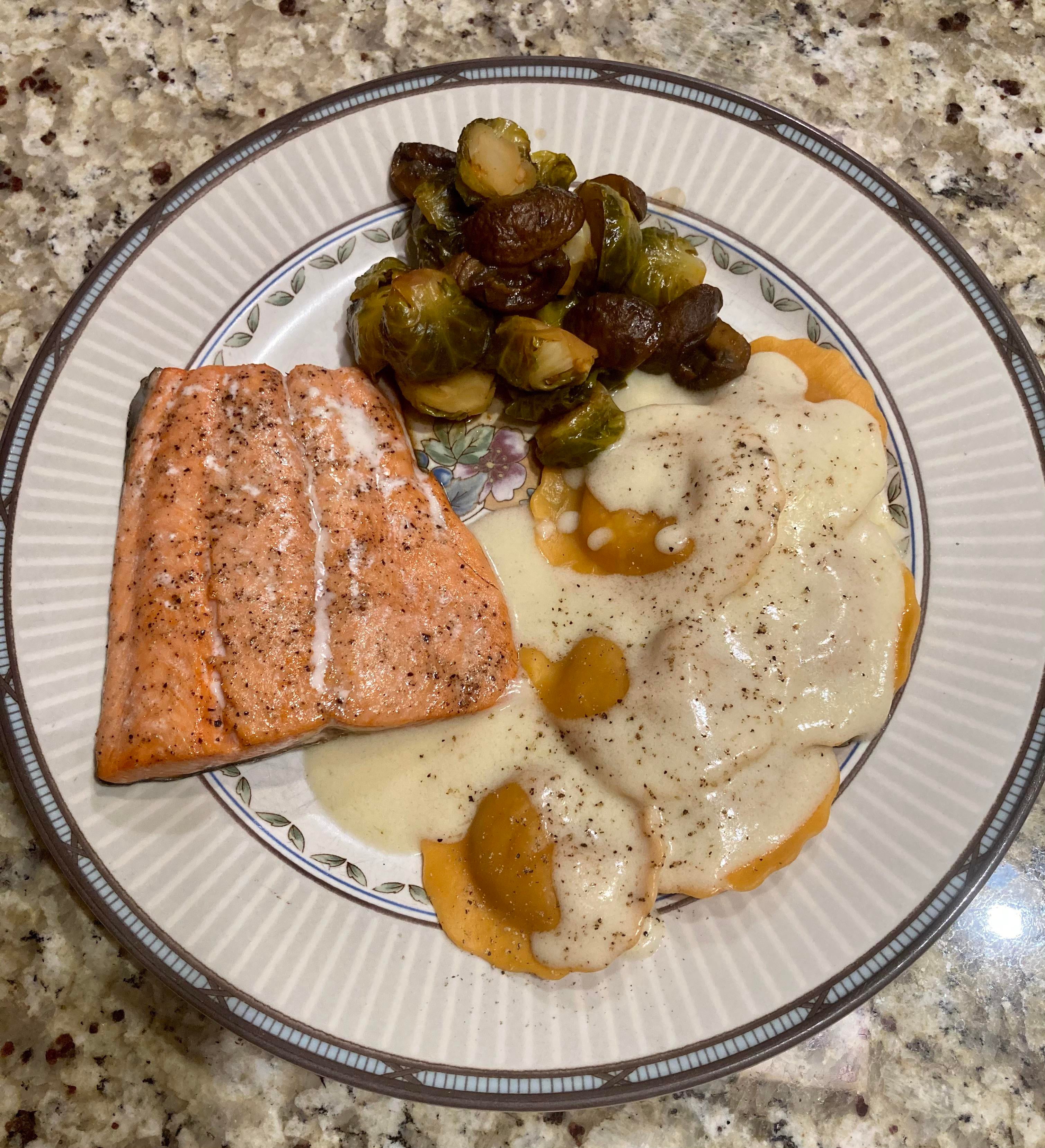 Roasted salmon, butternut squash ravioli w/ brown butter cream sauce