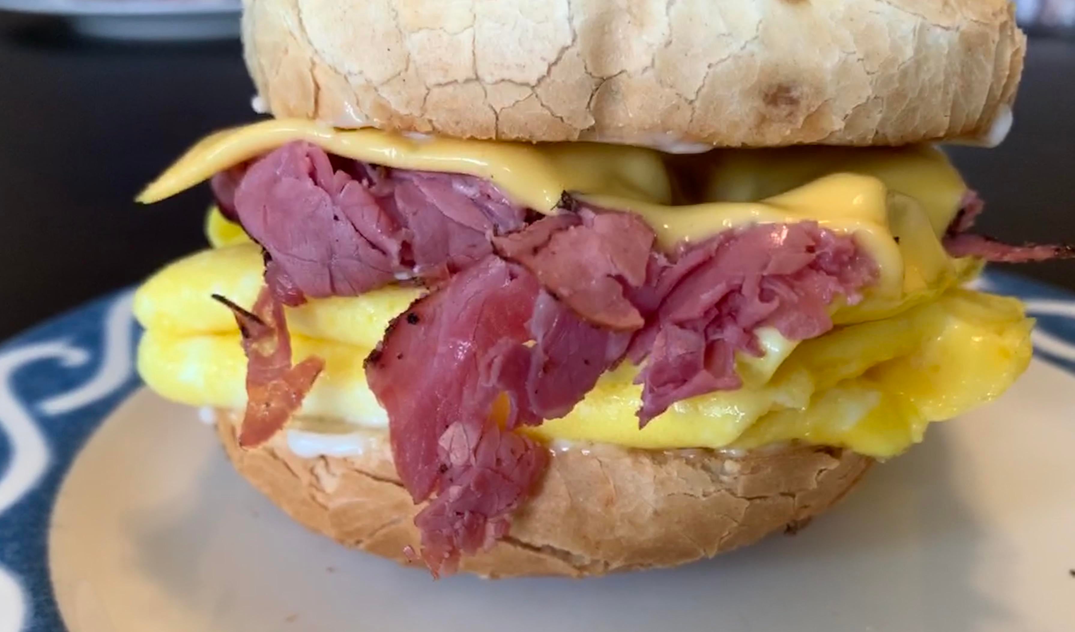 Pastrami, Scrambled Egg, American Cheese on an Onion Bagel Dining and