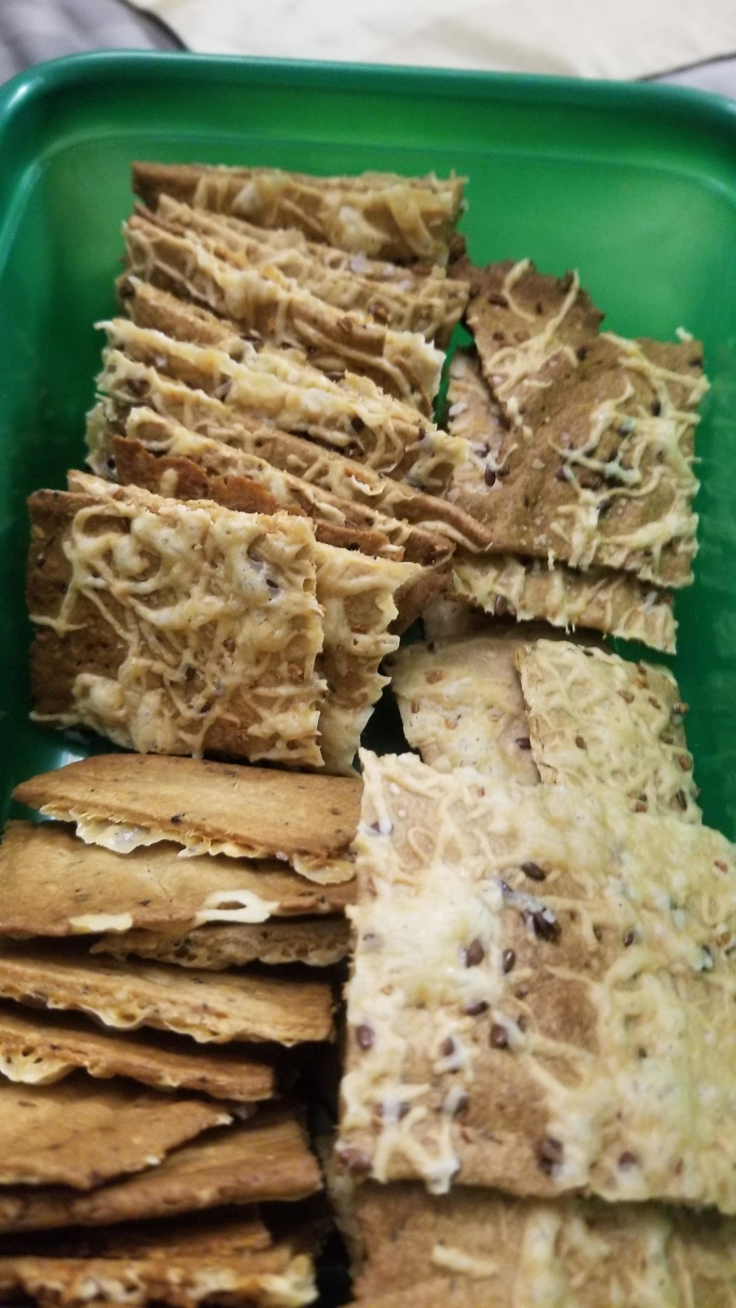 King Arthur's sourdough crackers topped w swiss cheese and everything