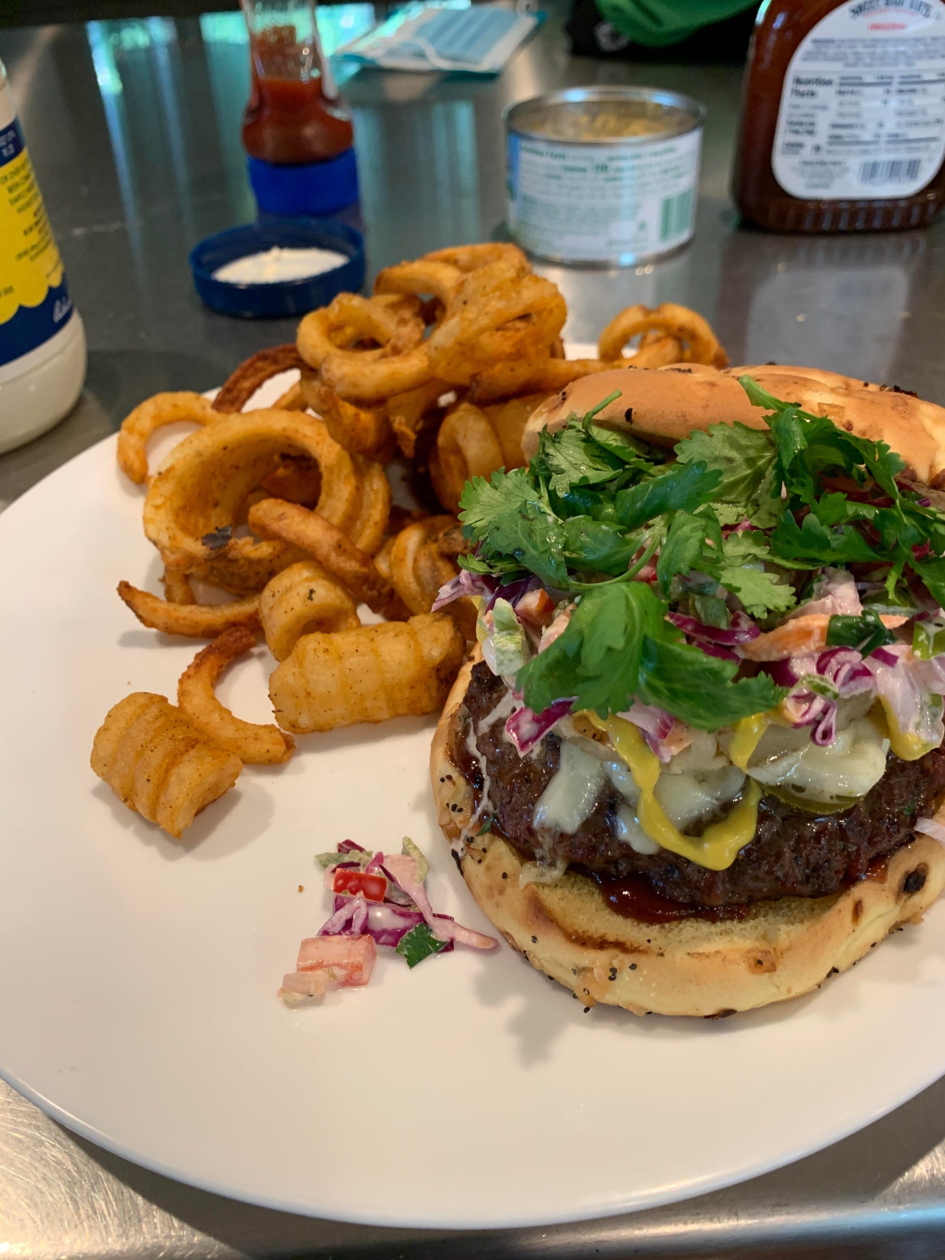Pineapple bbq burger w/swiss, slaw & cilantro on a onion roll. Dining
