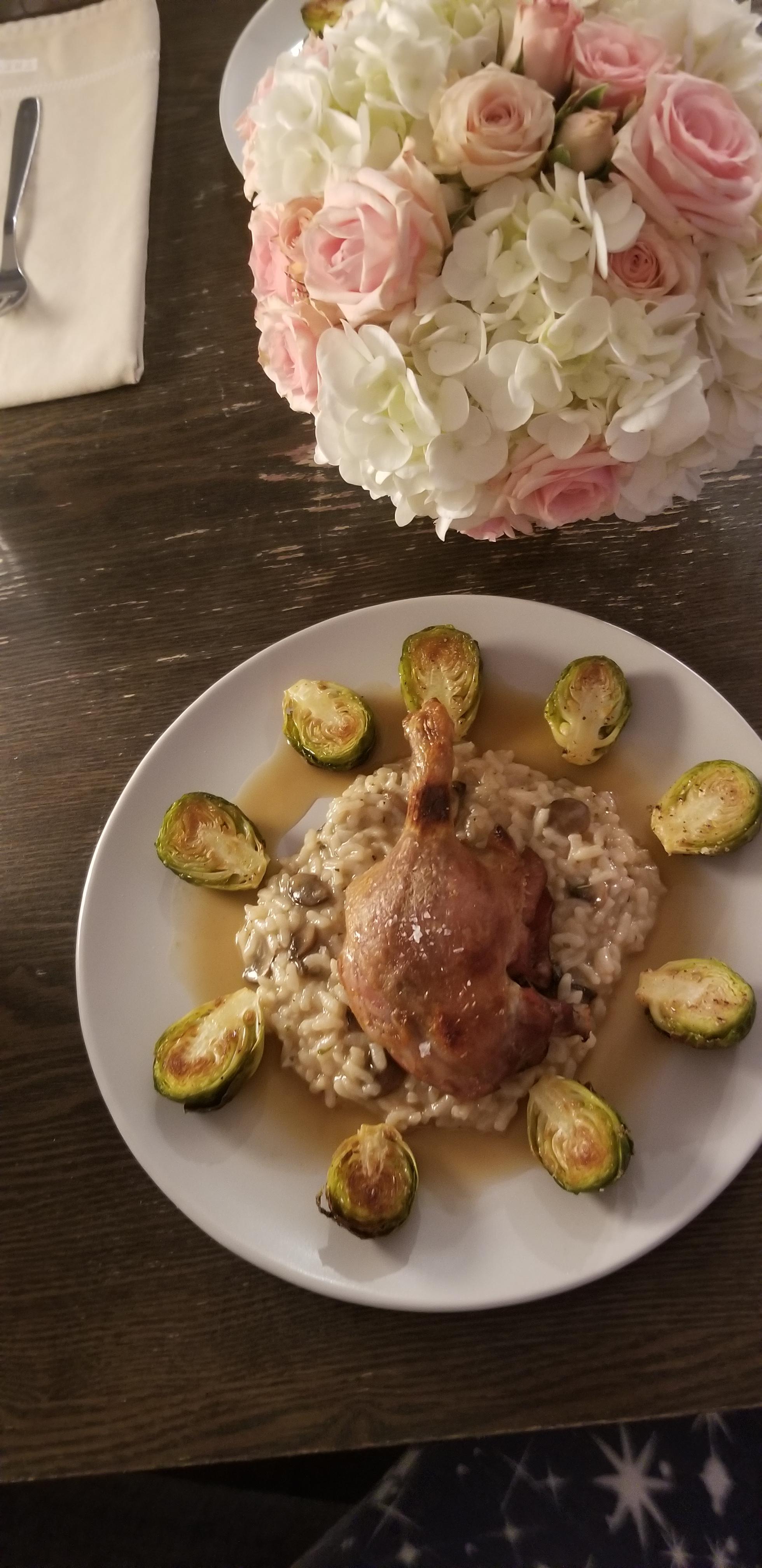 Duck confit with mushrooms risotto, roasted brussel sprouts, and duck