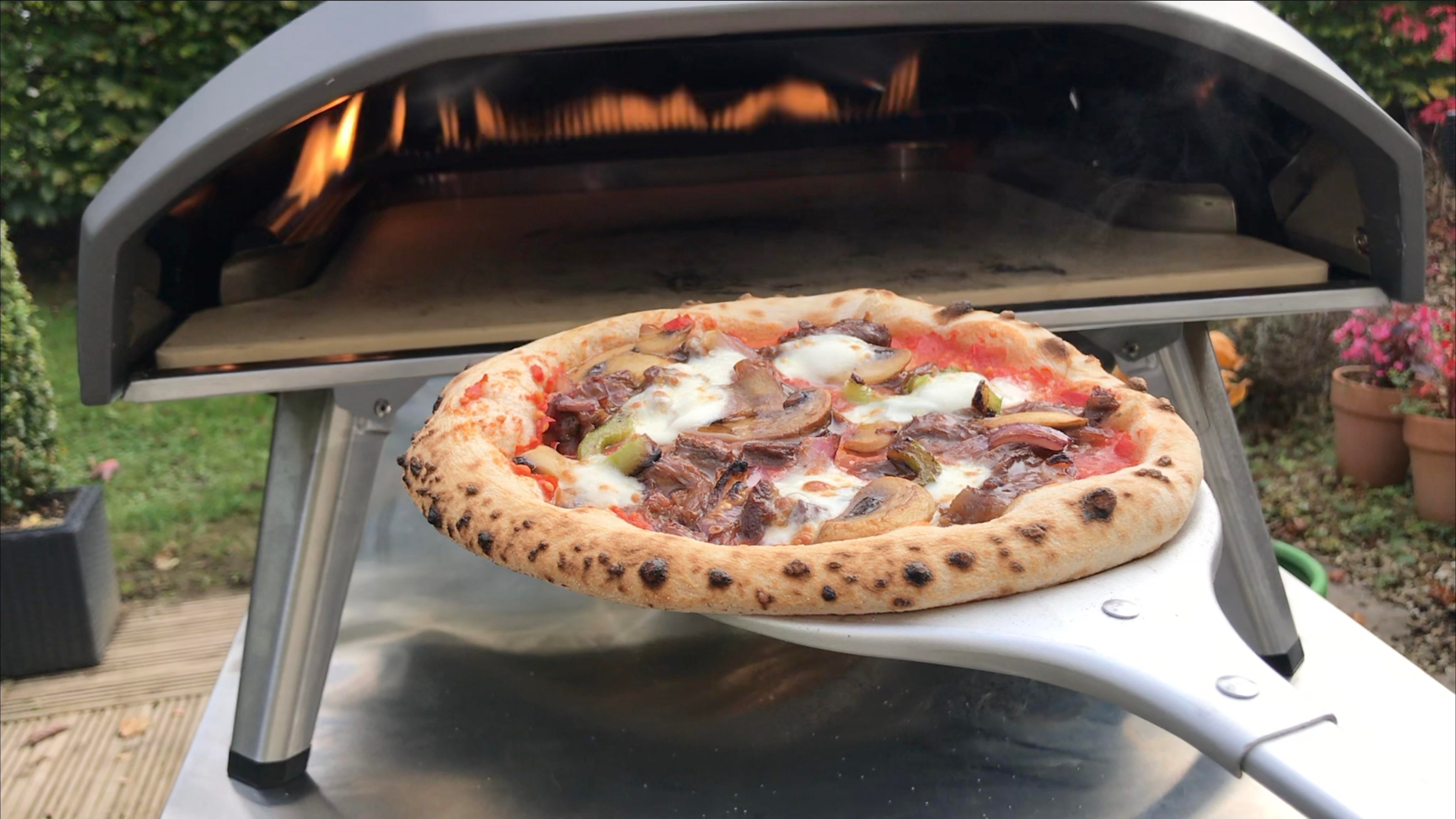 Homemade BBQ BEEF Pizza cooked in gas fired oven outside Dining and