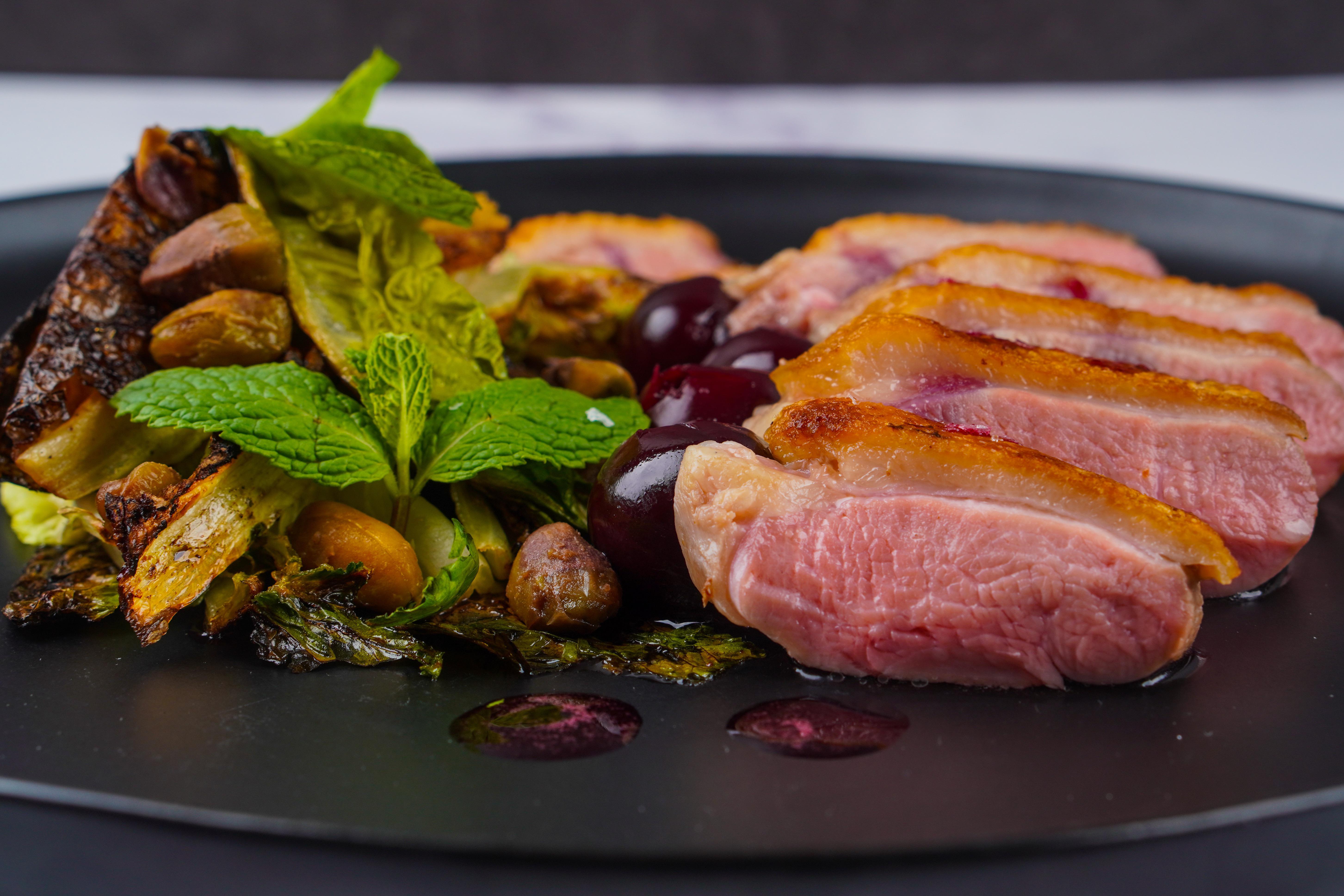 Crispy Skin Duck Breast with a Warm Gem Lettuce Salad with Fish Sauce Braised Pistachios, Wild