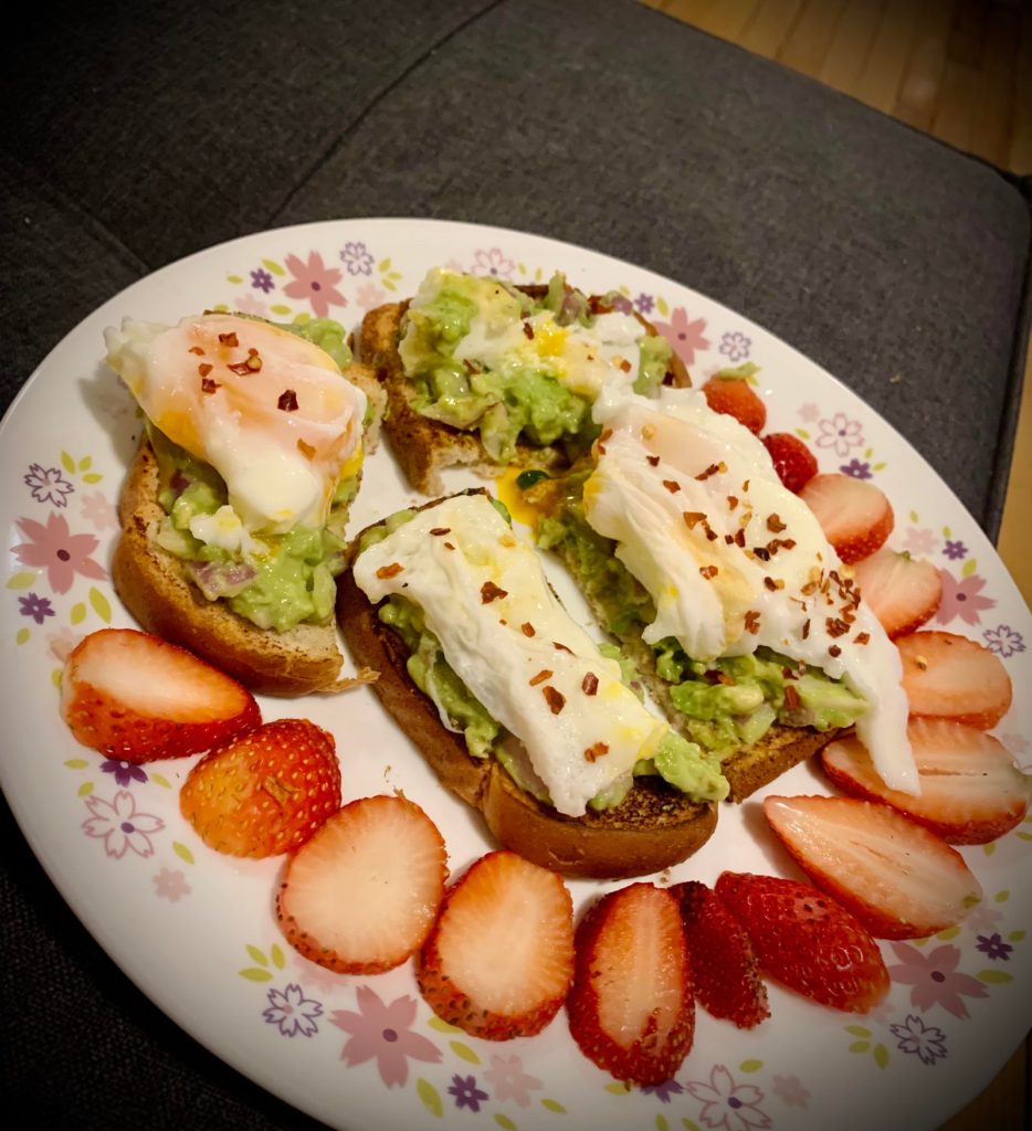 Brunch! Avocado toast with poached runny eggs and strawberries