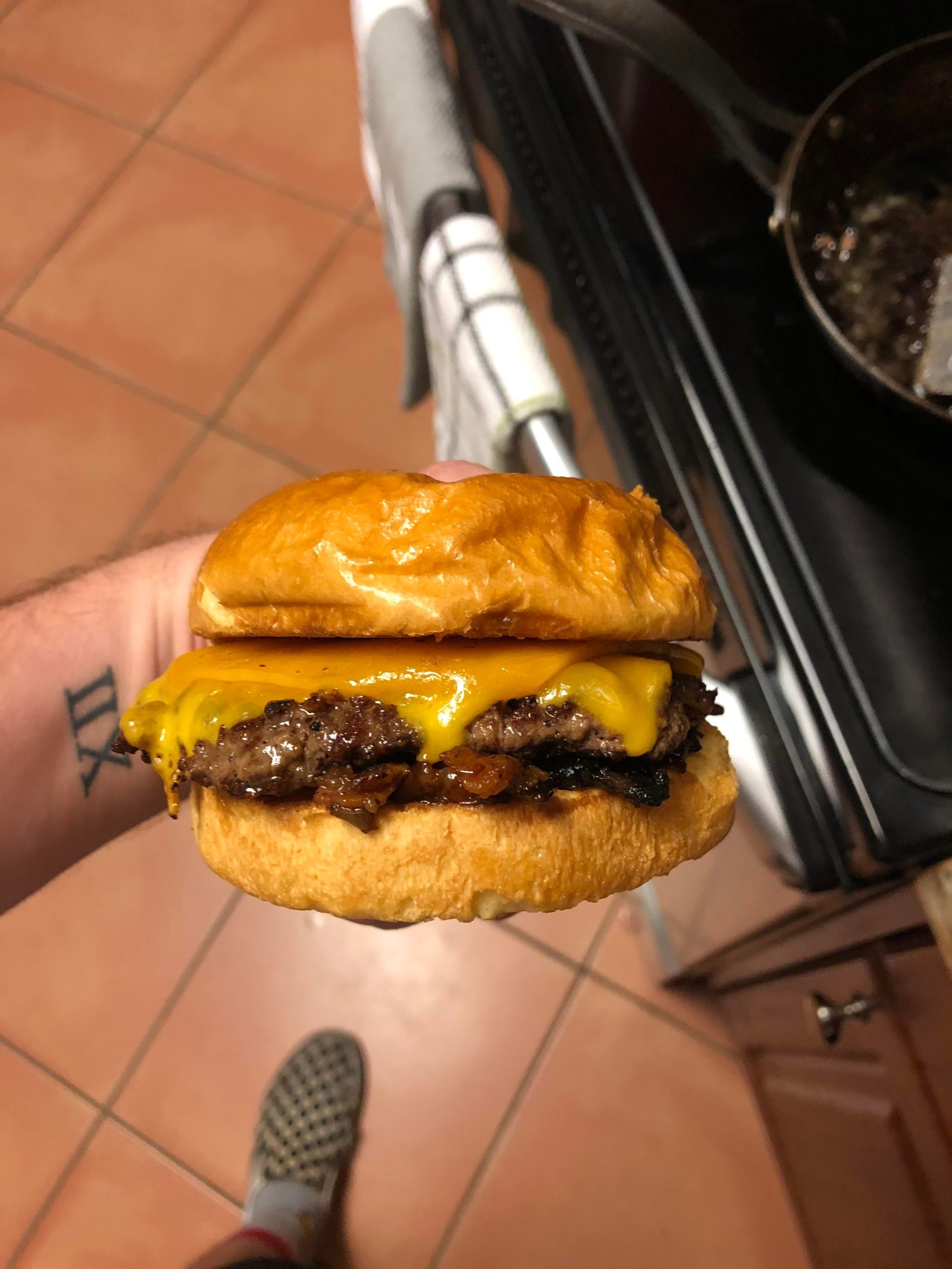 Brioche bun, 50/50 ribeye/sirloin patty, sharp cheddar, and bacon onion