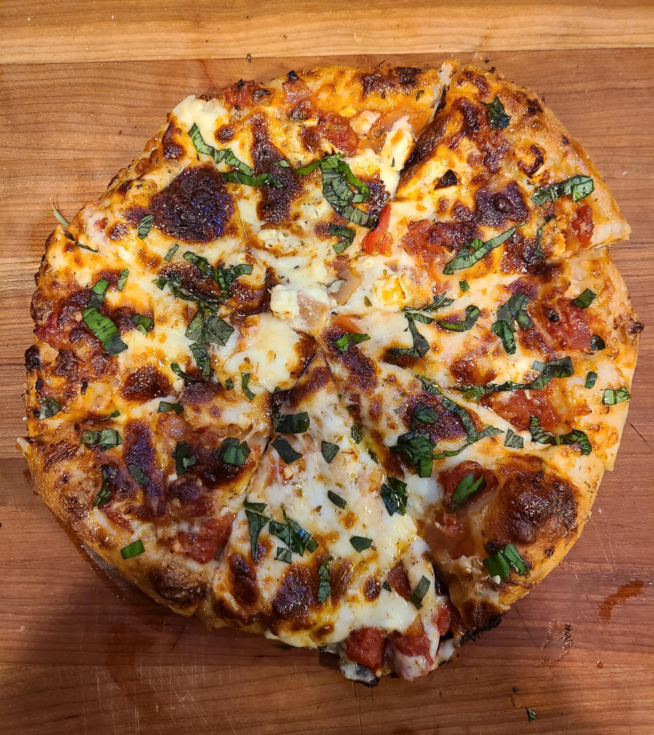 Four cheese pan pizza with fresh basil Dining and Cooking
