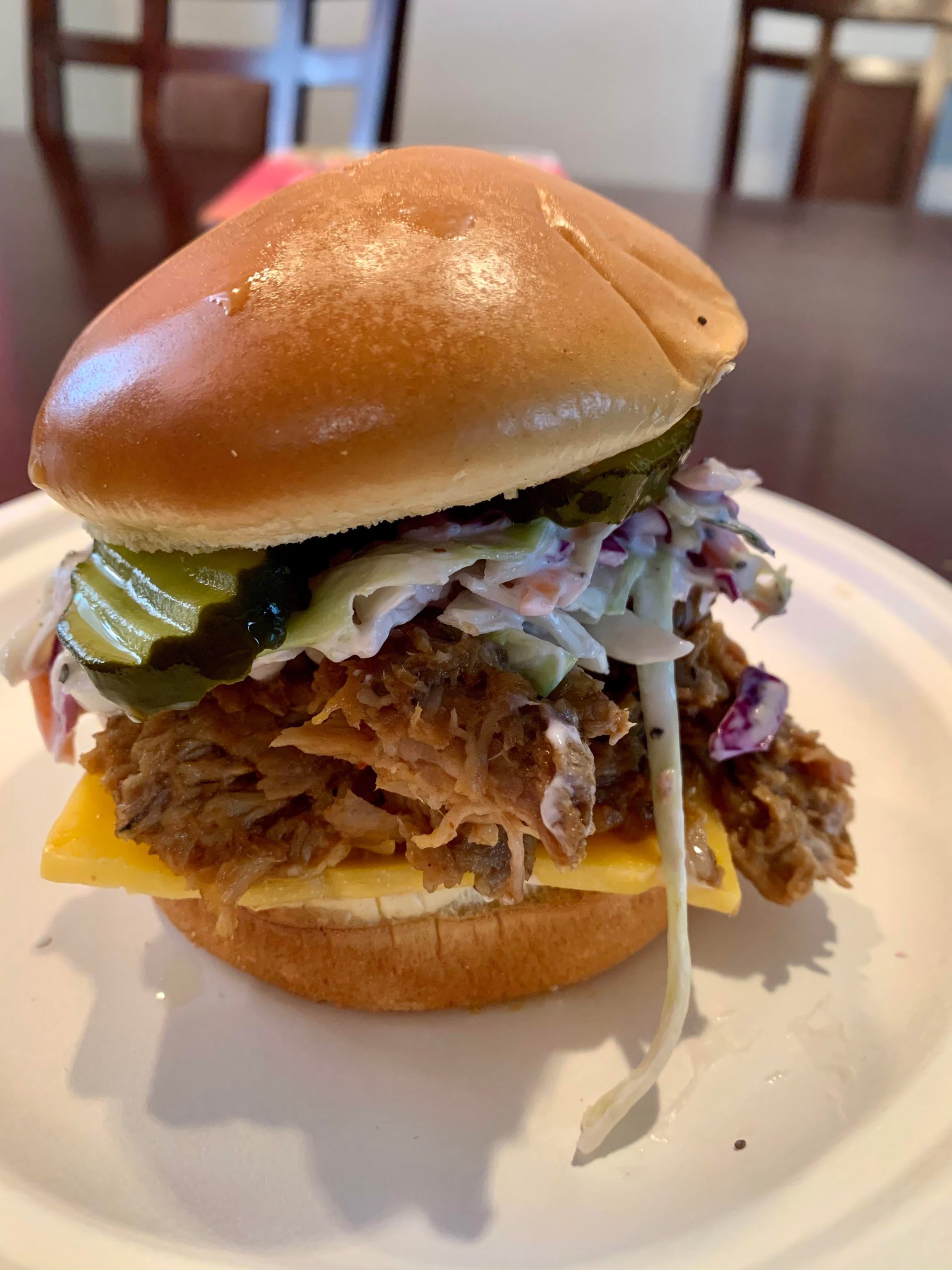 Pulled pork w sweet pickles and one made spicy bbq sauce and coleslaw
