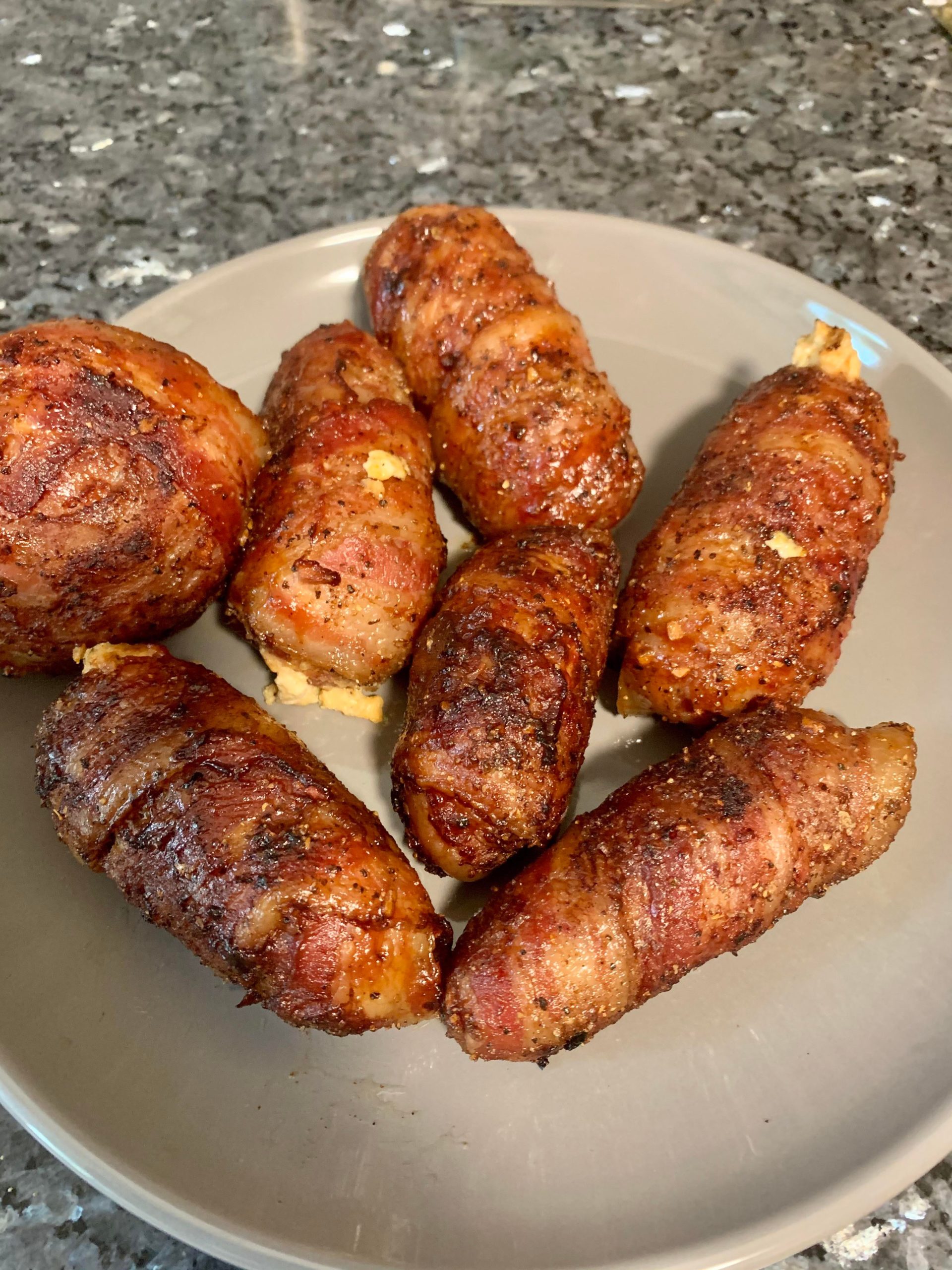Smoked Cheddar cheese and cream cheese stuffed jalapeños wrapped in