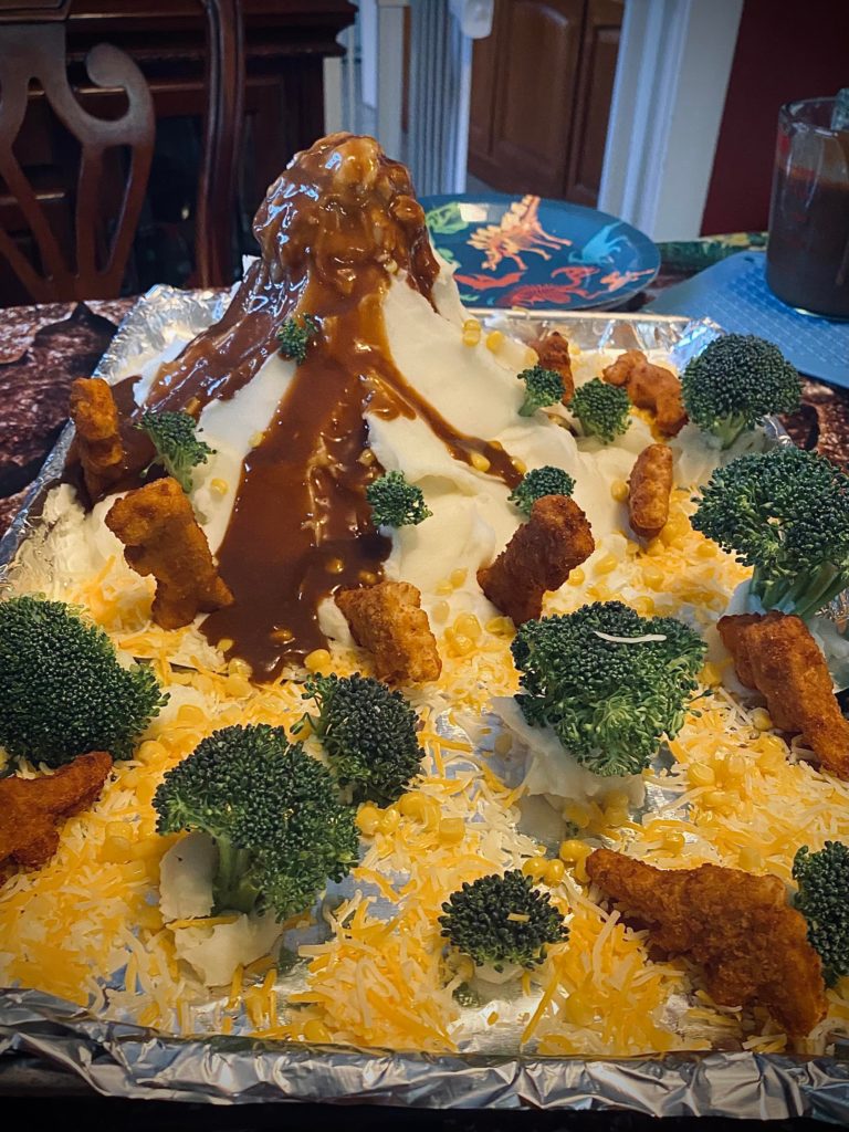 Mash potato volcano with brown gravy lava, broccoli trees, grated cheese grass, Dino nuggets (26th Birthday dinner)