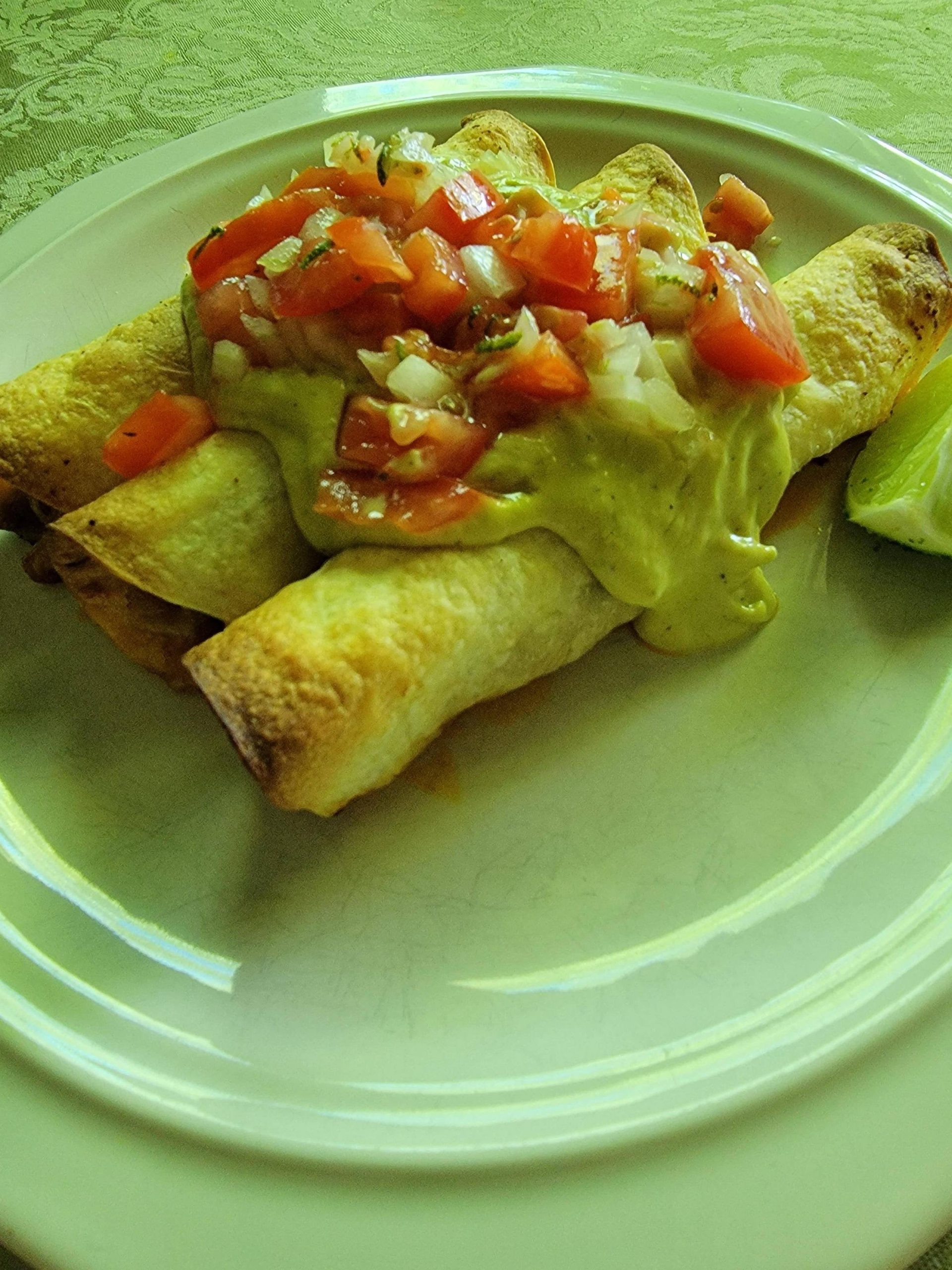 Fully loaded pork taquitos with Pico de Gallo, creamy guacamole and hot