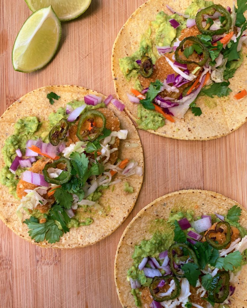 Breaded artichoke tacos with fried jalapeños, guac, lime slaw, cilantro and red onion
