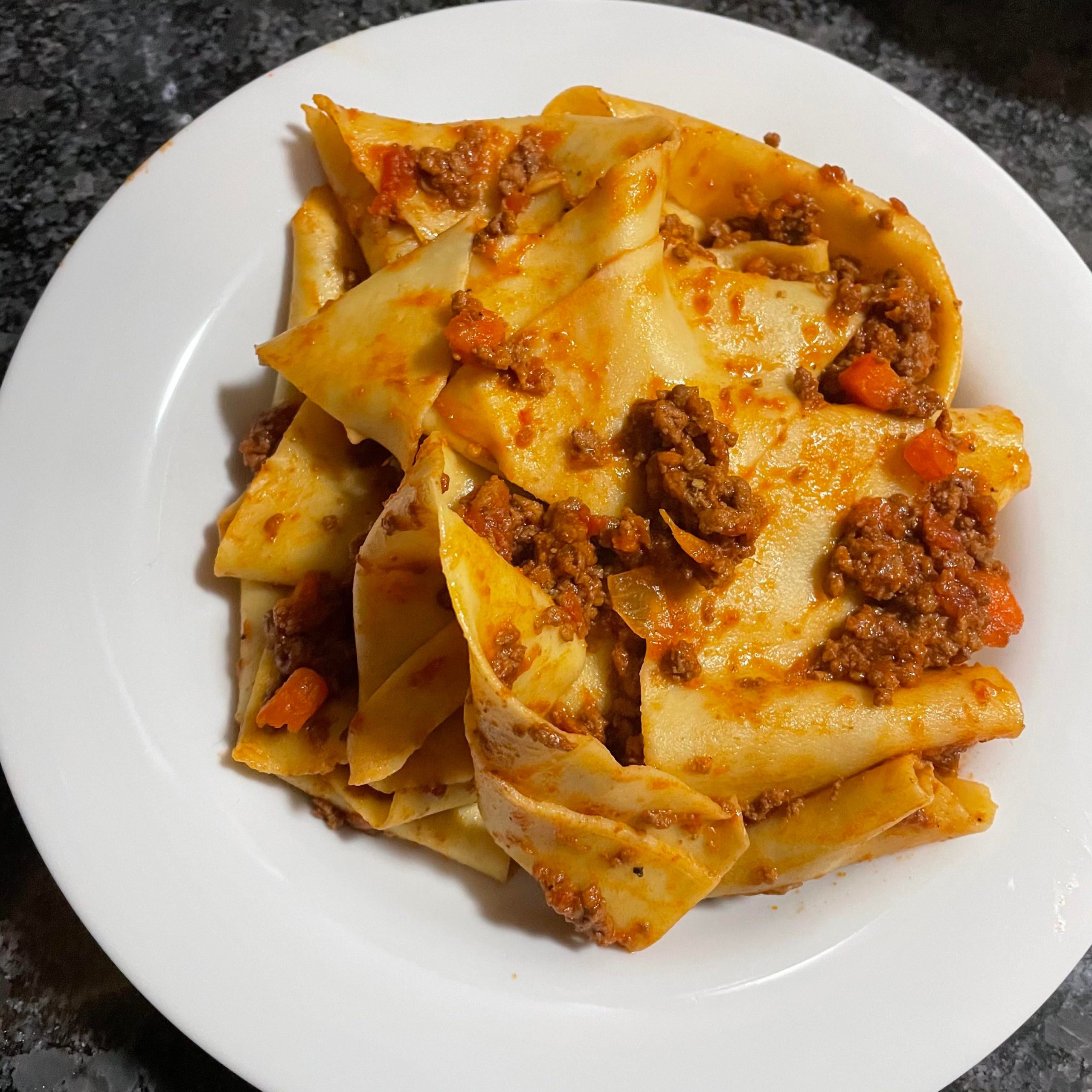 Fresh egg yolk pappardelle and a Bolognese ragù with beef and pork
