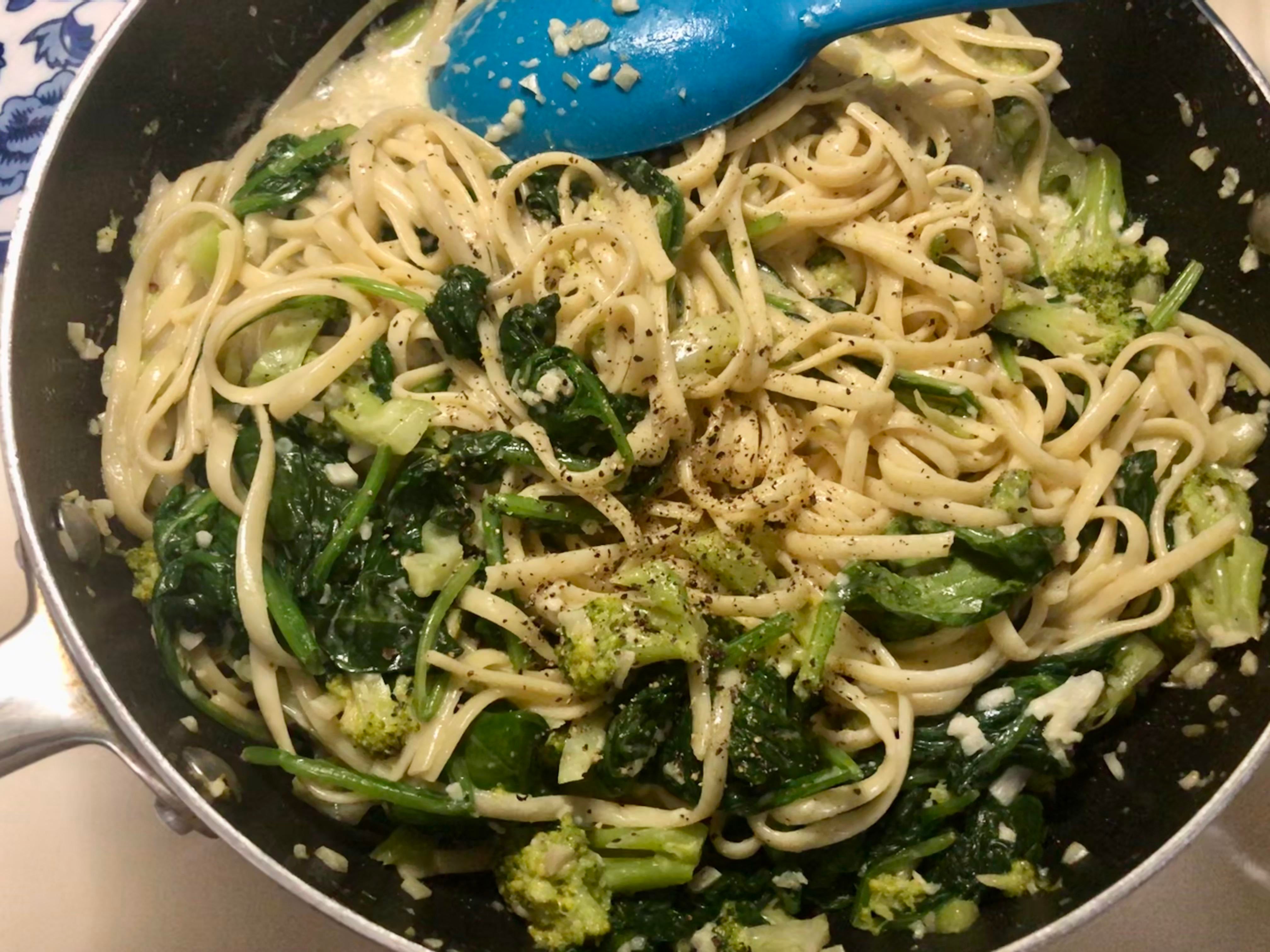 Linguine with broccoli and spinach in homemade alfredo sauce. Dining and Cooking