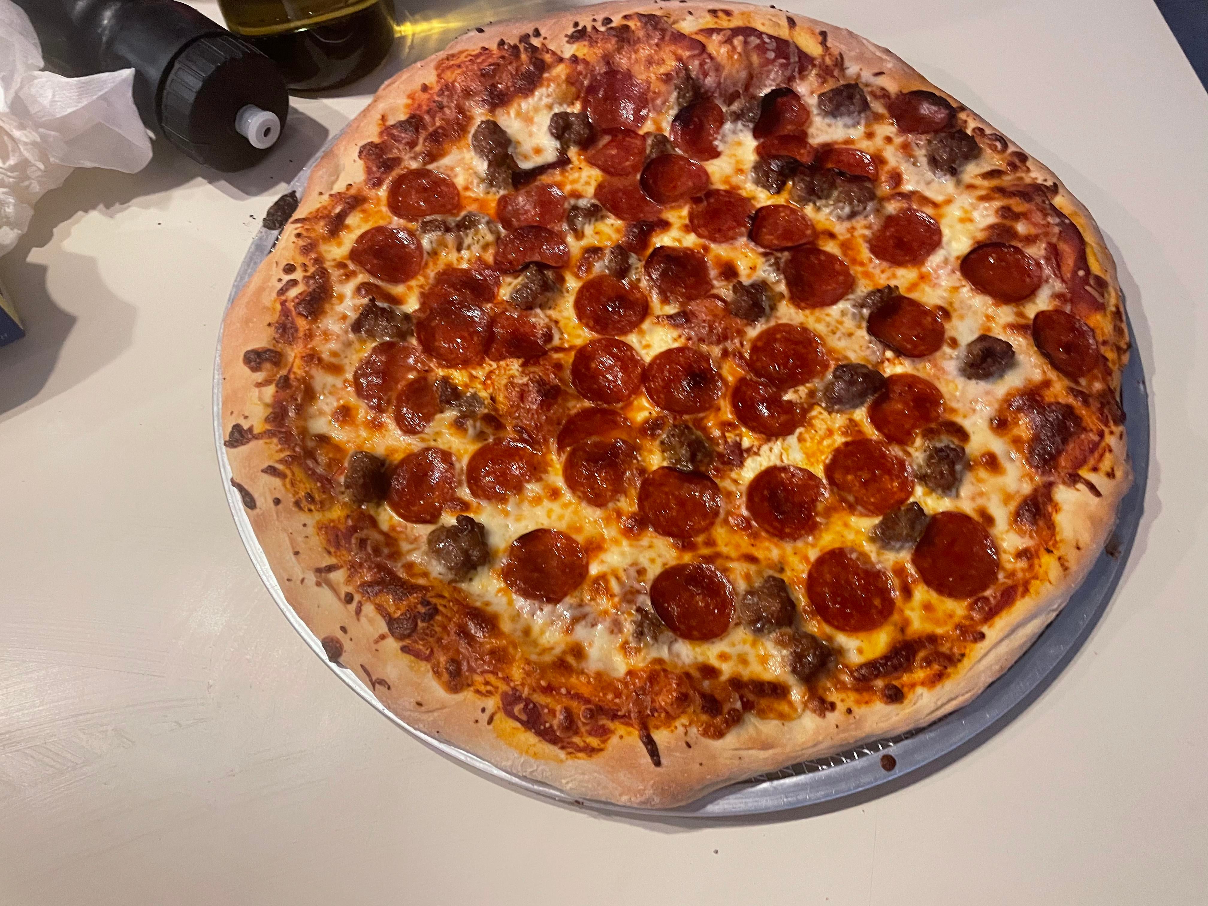 Pepperoni, Sausage, ricotta and Mozzarella New York Style. Dining and