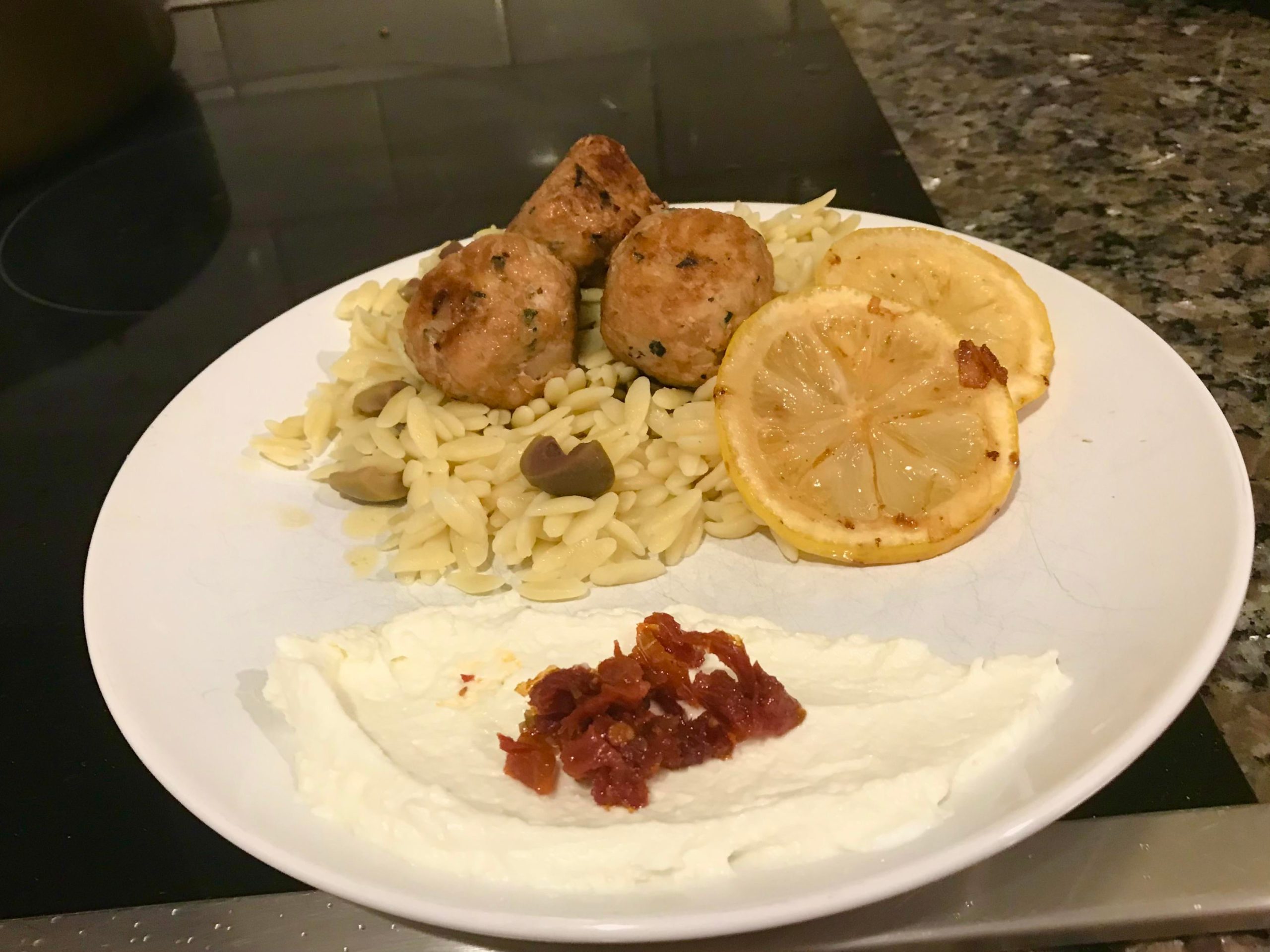 Chicken meatballs, lemon orzo with green olives, and whipped feta with sun dried tomatoes