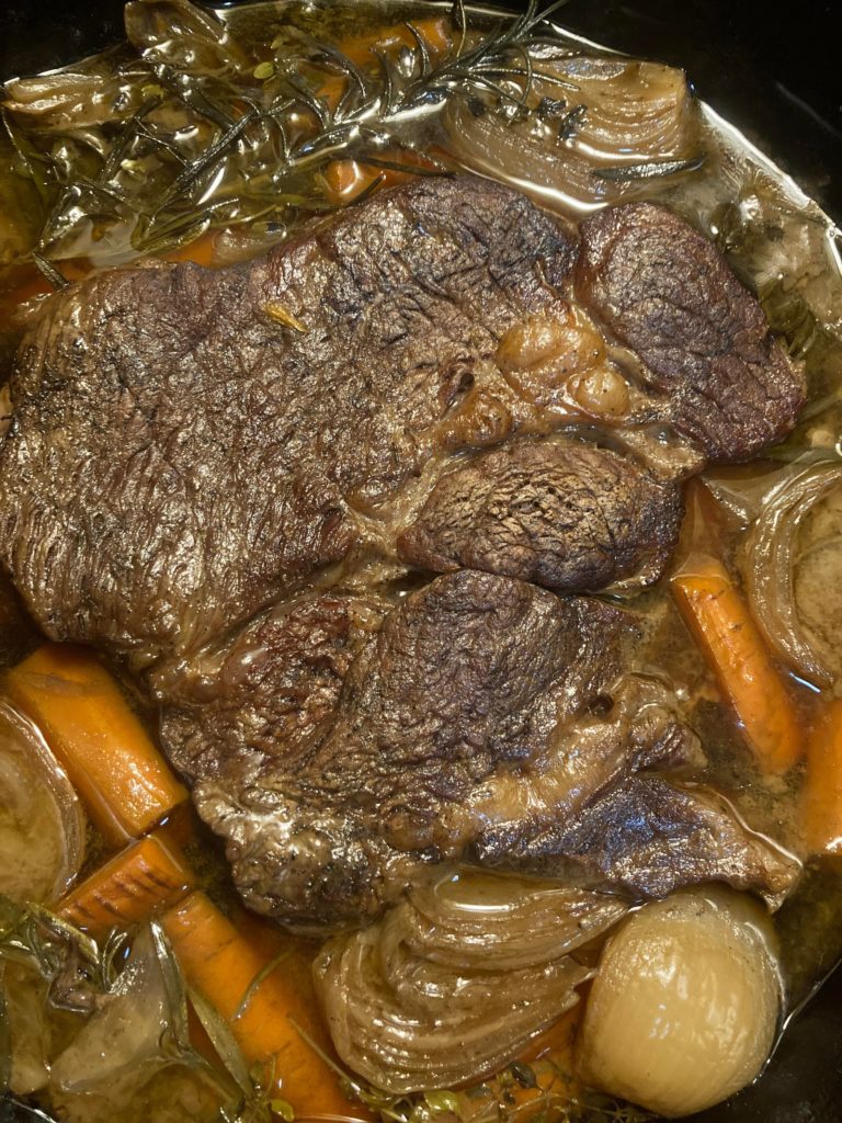 Pot roast with carrots and onions.
