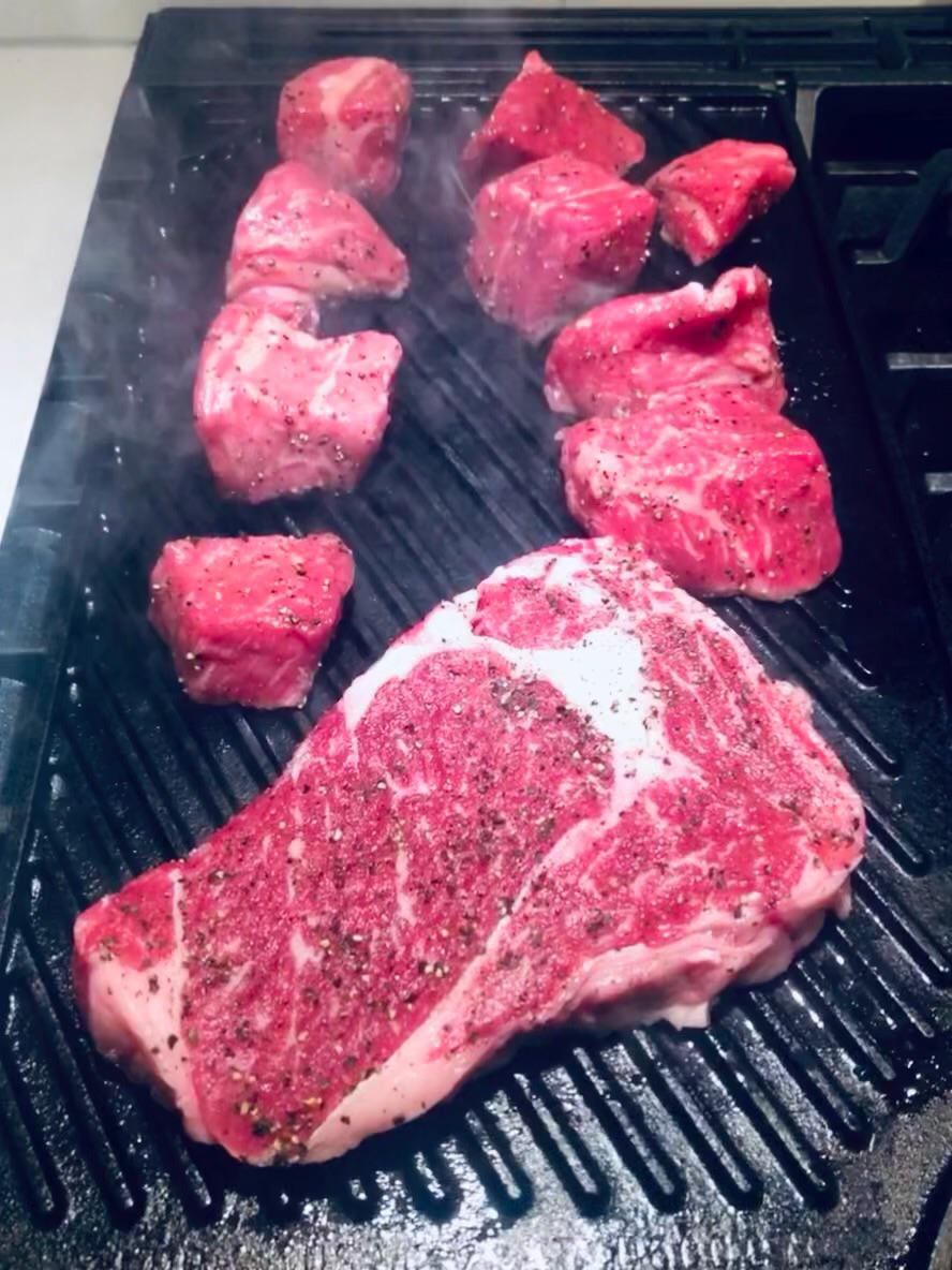 Steak tips and ribeye on the stovetop cast iron grill Dining and Cooking