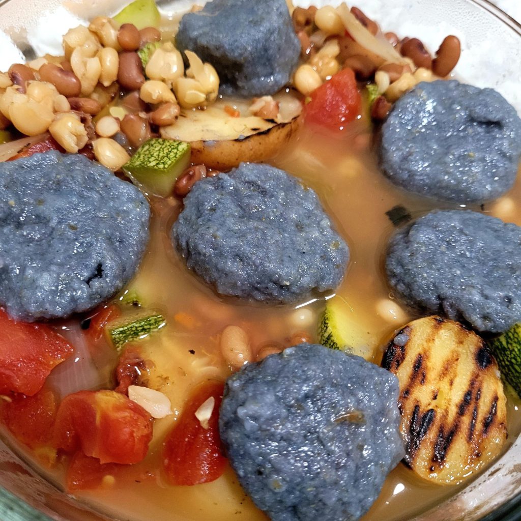 K'ineeshbizhii - Navajo Blue Corn & Juniper Ash Dumplings in a Stew of Neeshjizhii- Navajo corn buried in the ground and cooked with coals overnight, then dried and shelled , tepary beans, squash, Chiles, tomatoes , potatoes, onions , garlic , sage